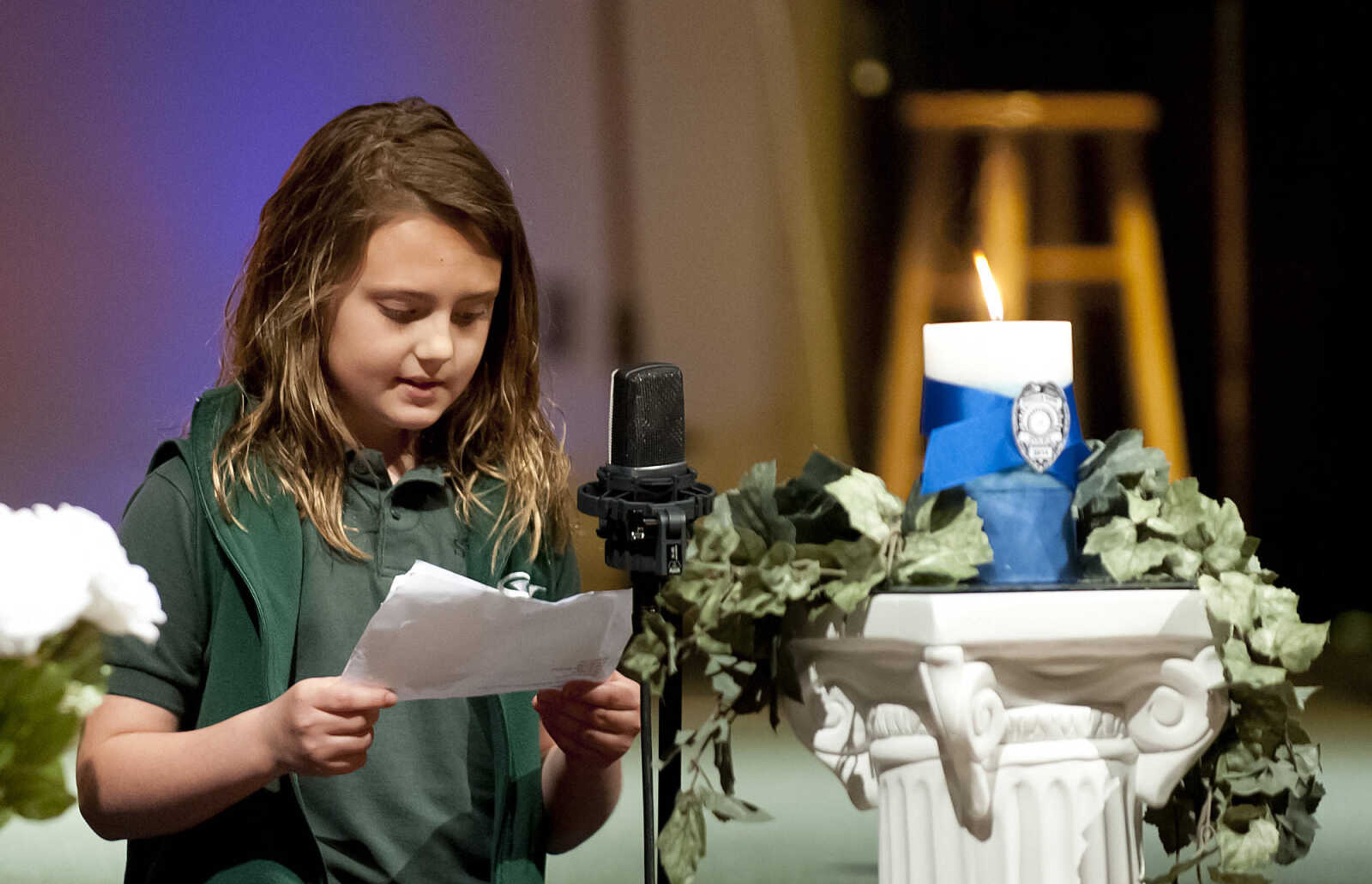 Madison Bonham, 9, reads her award-winning poem about police officers during the Senior and Lawmen Together Law Enforcement Memorial Friday, May 9, at the Cape Bible Chapel. The annual memorial honored the 48 Southeast Missouri law enforcement officers that have died in the line of duty since 1875.