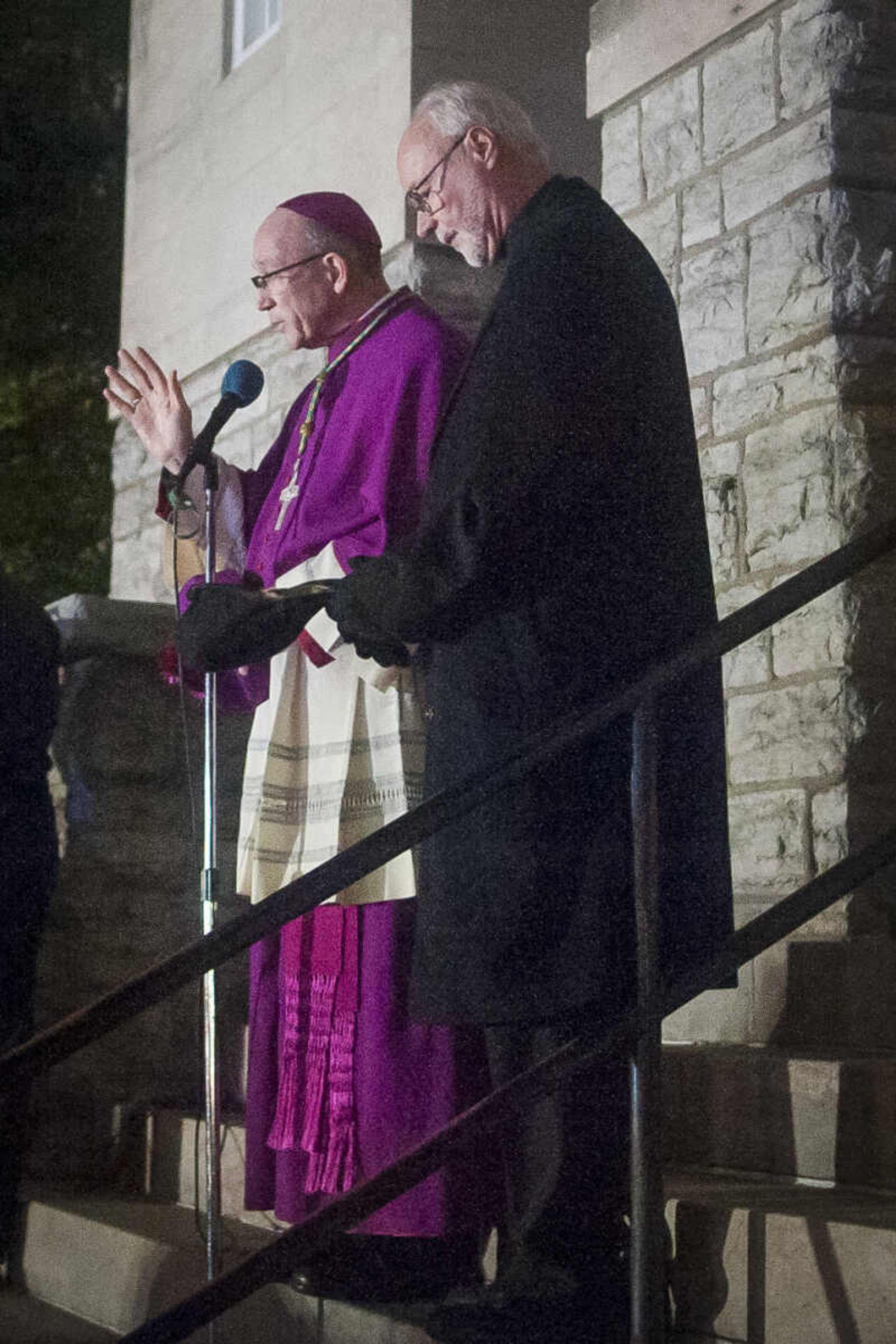 Father John Harth, right, stands with Bishop Edward Rice as he  speaks before a Marian procession Sunday, Dec. 8, 2019, to recognize Immaculate Conception Catholic Church's 170-year anniversary and to mark the beginning of the church's capital campaign to build a new church building in Jackson.