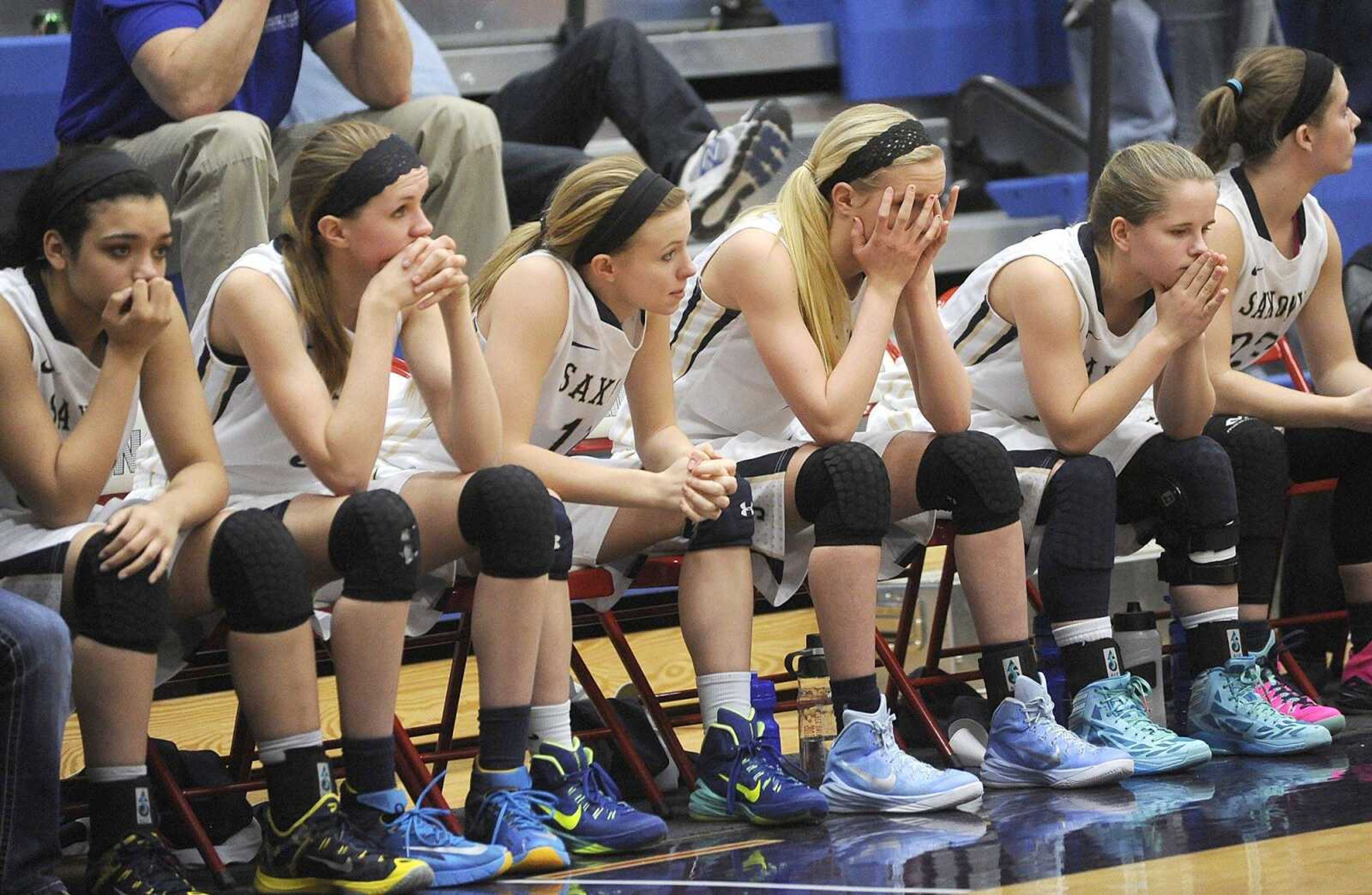 Saxony Lutheran players on the bench wait out the final seconds of the Class 3 state quarterfinal against Park Hills Central Saturday, March 7, 2015 in Hillsboro, Missouri.