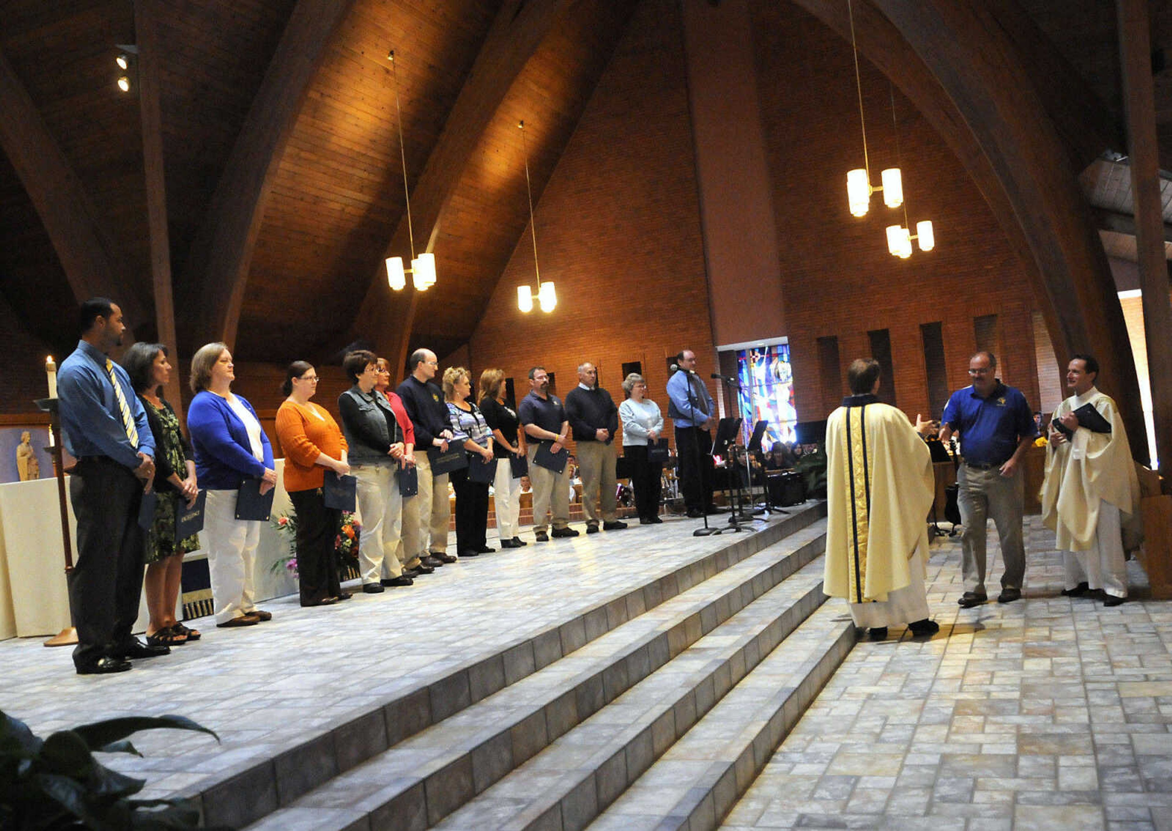 KRISTIN EBERTS ~ keberts@semissourian.com

Father Milton Ryan, right and Father Joseph Williams recognize St. Vincent teachers during Mass at St. Vincent De Paul parish in Perryville, Mo., on Friday, Oct. 15, 2010. The Mass was followed by an assembly to celebrate the school's recognition on the list of the best 50 Catholic secondary schools in America, presented by the Catholic High School Honor Roll. This is the first time St. Vincent has received this distinction.