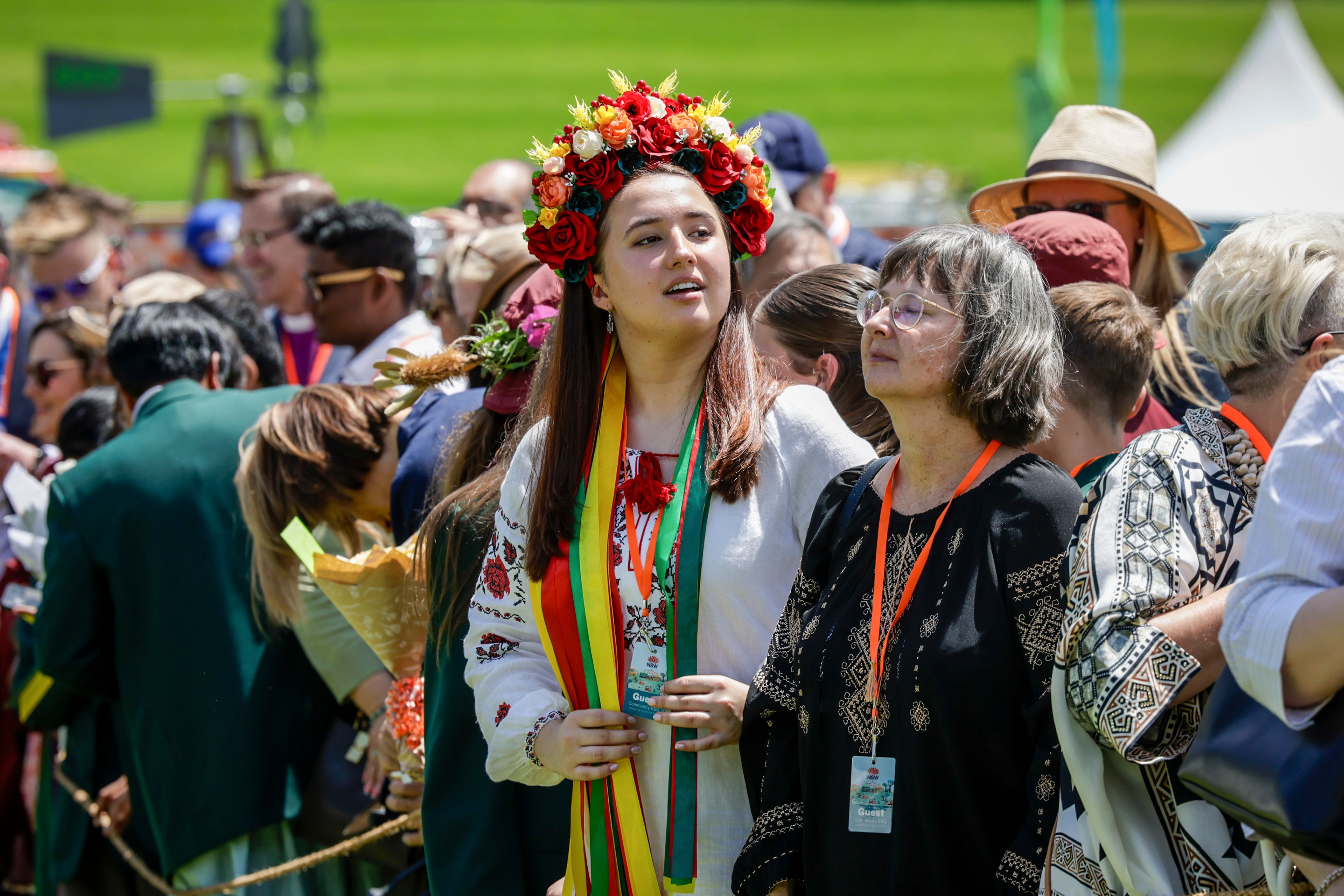 Members of the public wait for Britain's King Charles III and Queen Camilla to arrive to attend the Premier's Community BBQ on Tuesday Oct. 22, 2024 in Sydney, Australia. (Brook Mitchell/Pool Photo via AP)