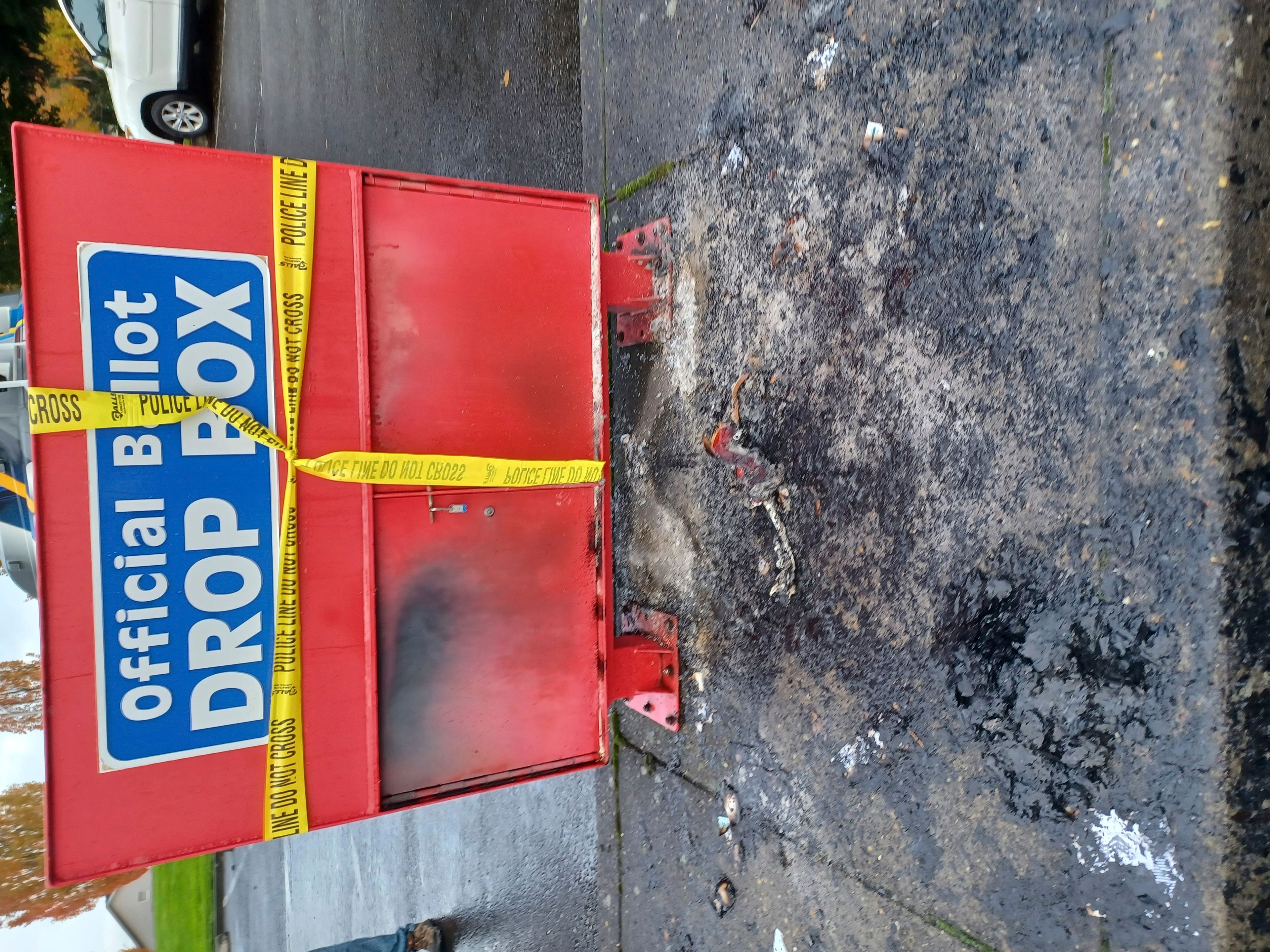 Police tape surrounds a ballot drop box damaged by a fire on Monday, Oct. 28, 2024, in Vancouver, Wash. (Monika Spykerman/The Columbian via AP)