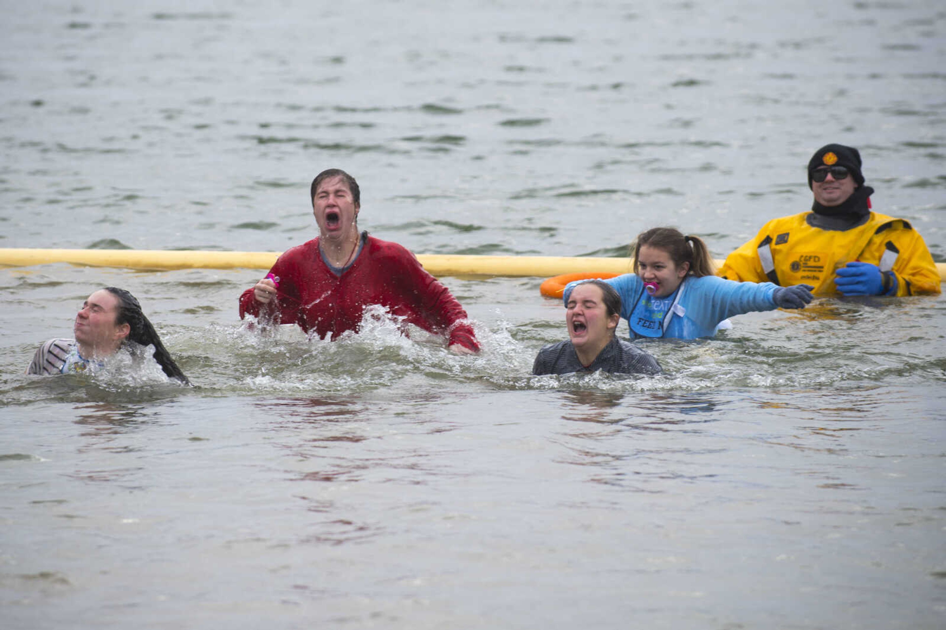 A group of plunge participants remerge after dipping underwater during the Polar Plunge benefit for Special Olympics Missouri on Saturday, Feb. 3, 2018, at Trail of Tears State Park.