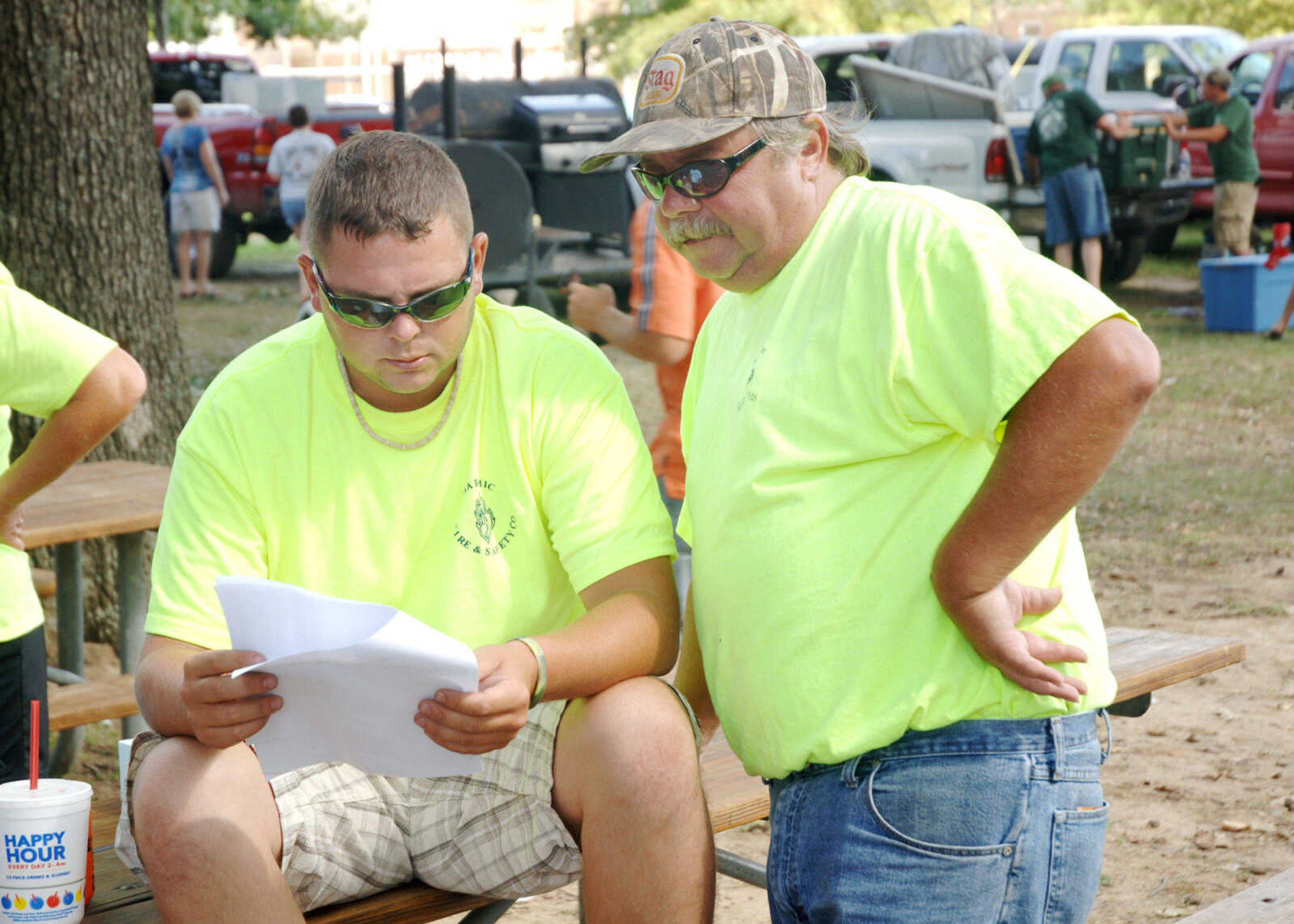 Jared Dewrock, left, looks over the final scores from the Cape BBQ Fest, Saturday, August 22, 2009, with Danny Dewrock.