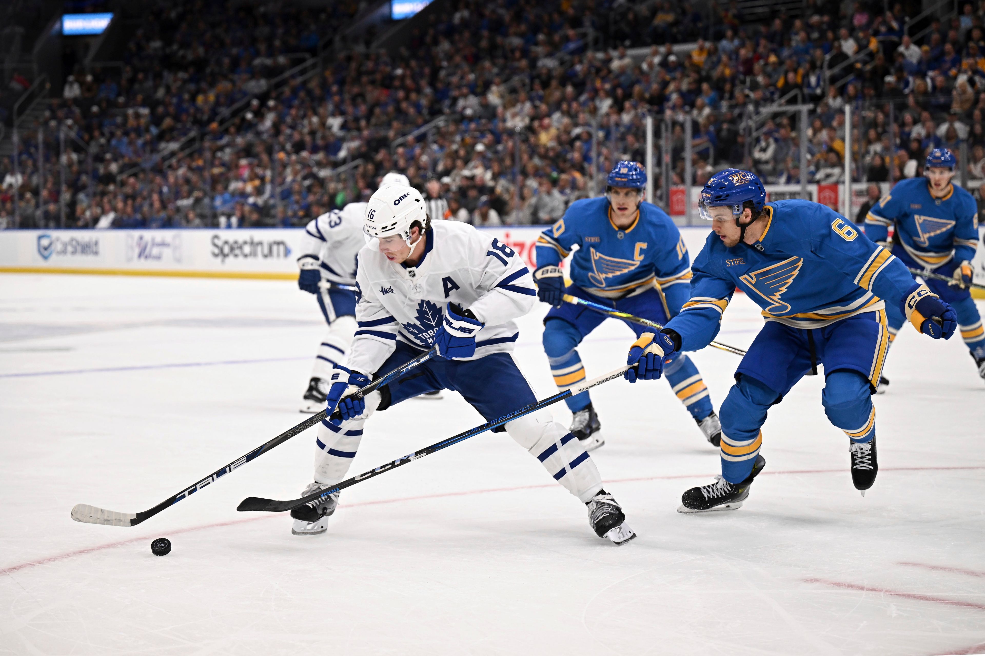 Toronto Maple Leafs' Mitch Marner (15) controls the puck as St. Louis Blues' Philip Broberg (6) defends during the first period of an NHL hockey game Saturday, Nov. 2, 2024, in St. Louis. (AP Photo/Connor Hamilton)