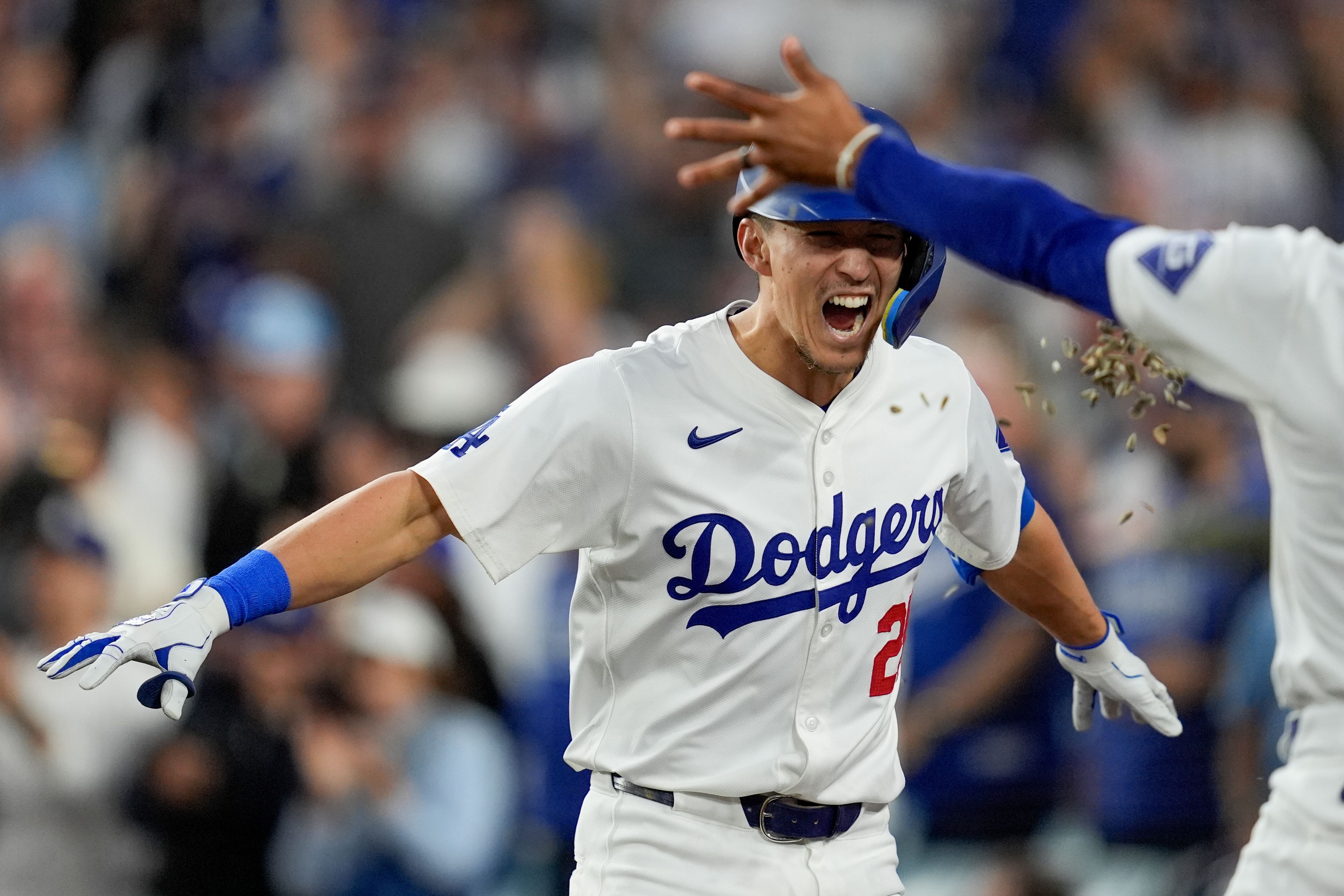 Los Angeles Dodgers' Tommy Edman celebrates a two-run home run against the New York Mets during the third inning in Game 6 of a baseball NL Championship Series, Sunday, Oct. 20, 2024, in Los Angeles. (AP Photo/Ashley Landis)