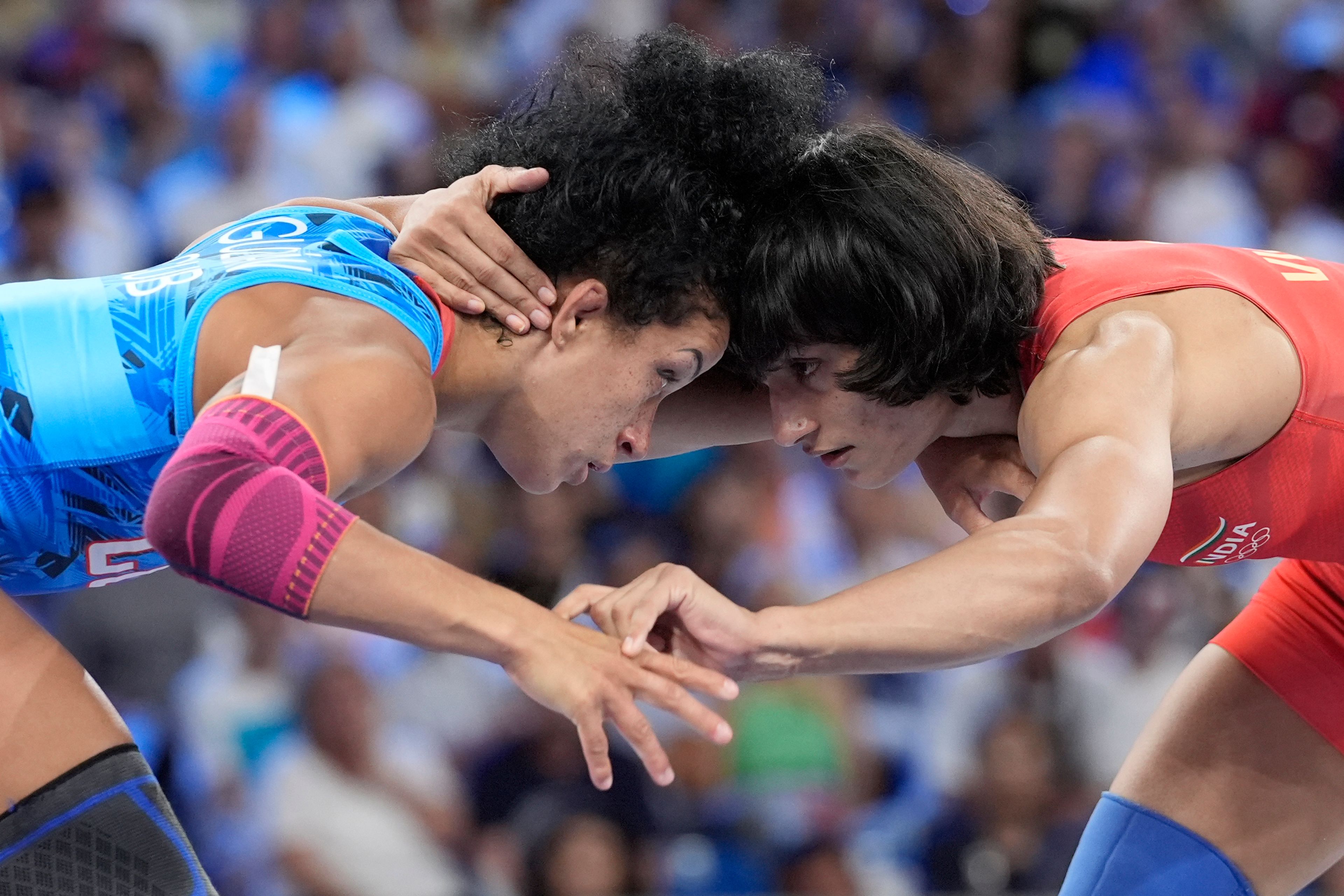 India's Vinesh Vinesh and Cuba's Yusneylys Guzman, left, compete during their women's freestyle 50kg wrestling semifinal match, at Champ-de-Mars Arena, during the 2024 Summer Olympics, Tuesday, Aug. 6, 2024, in Paris, France. (AP Photo/Eugene Hoshiko)