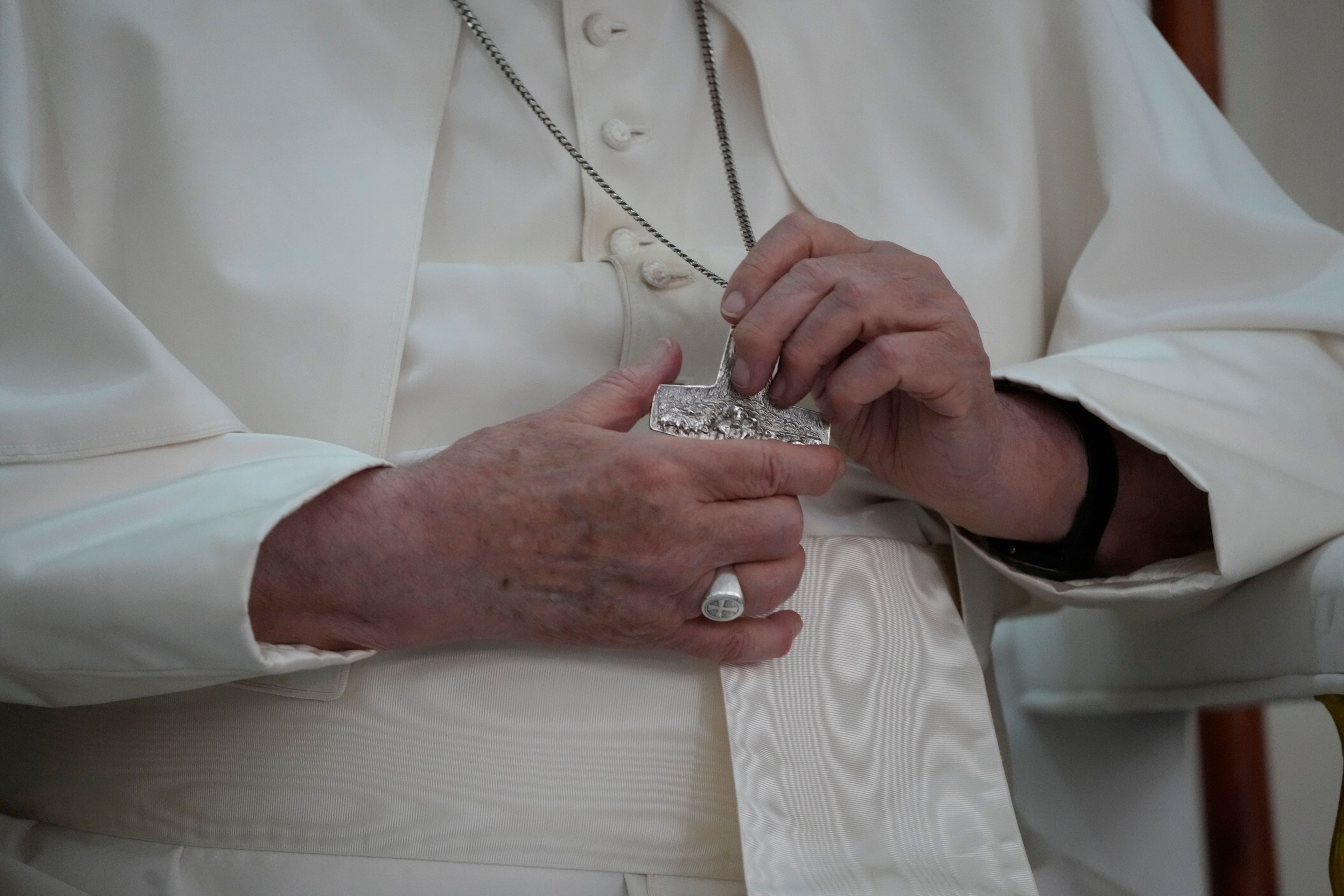 Pope Francis holds his cross pendant during a visit at the 'Irmas ALMA' (Sisters of the Association of Lay Missionaries) School for Children with Disabilities in Dili, East Timor, Tuesday, Sept. 10, 2024. Pope Francis has indirectly acknowledged the abuse scandal in East Timor involving its Nobel Peace Prize-winning independence hero Bishop Carlos Filipe Ximenes Belo. (AP Photo/Gregorio Borgia)