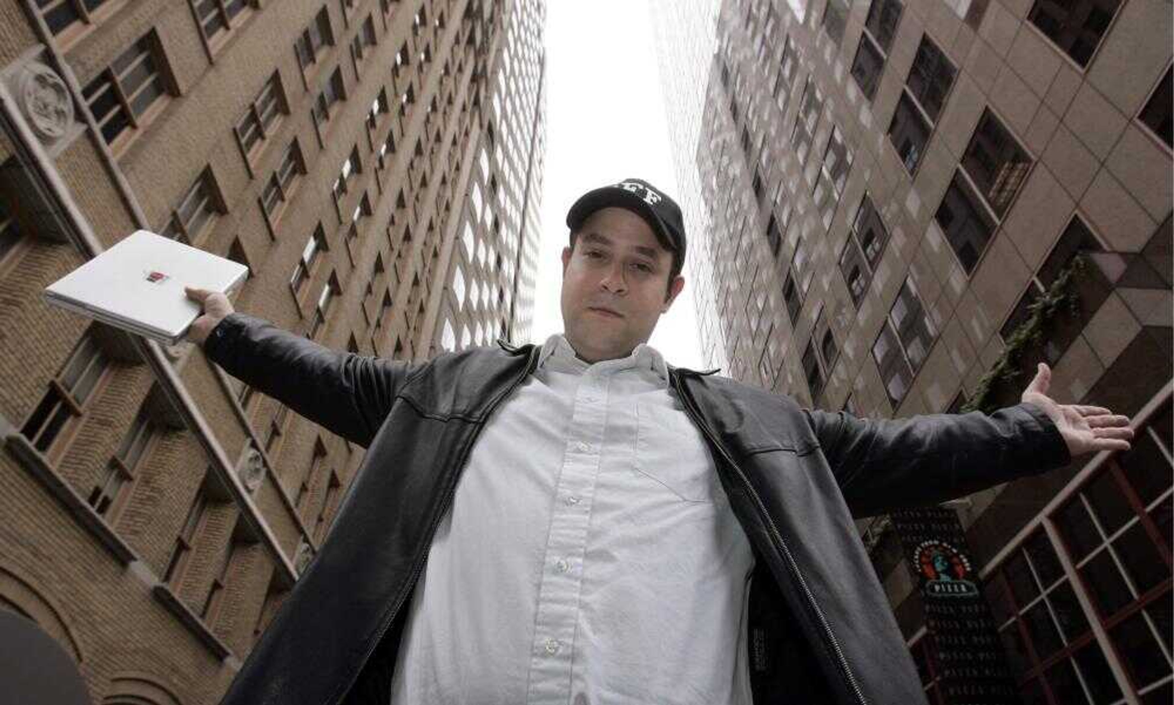 Kevin Bankston posed between downtown office buildings Friday in San Francisco. Google Inc. bills the latest twist on its online maps as "Street View," but it looks a bit like "Candid Camera" as you cruise through the panorama of pictures that captured fleeting moments in neighborhoods scattered across the country. (PAUL SAKUMA ~ Associated Press)