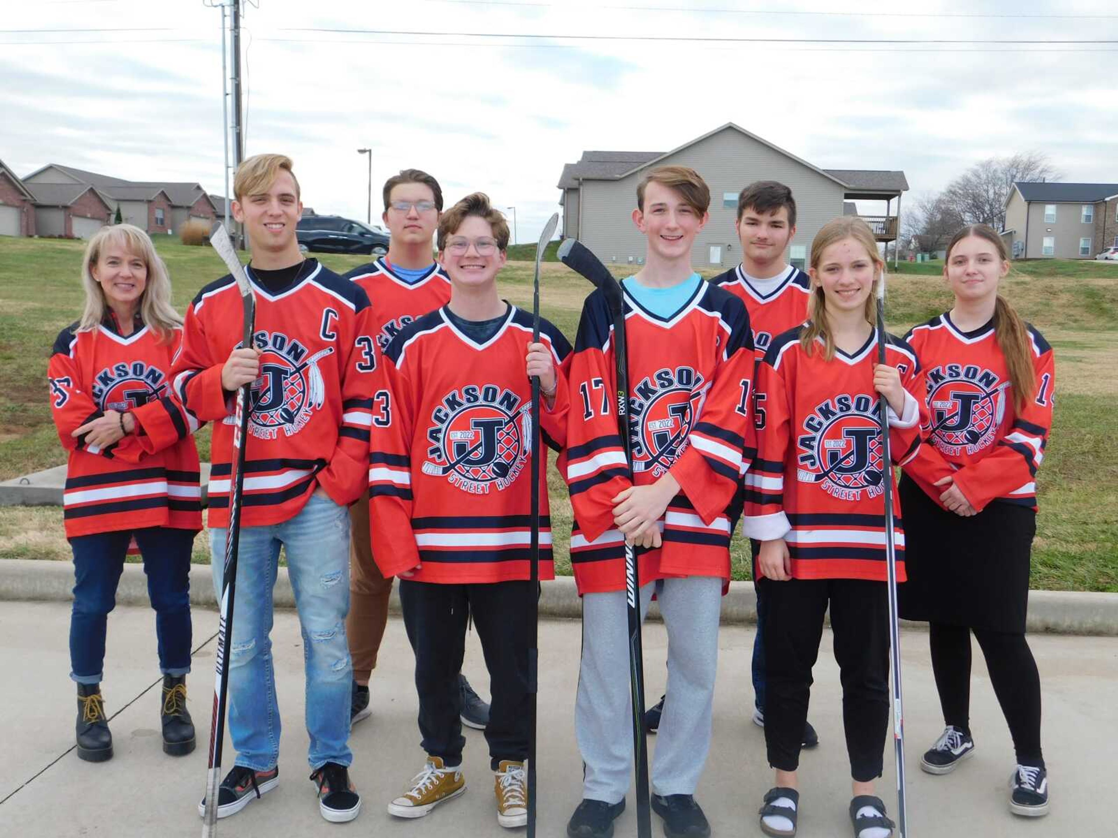 Since 2022, Jackson Street Hockey has grown from a few friends playing in front of their homes to a network of dozens of players and several hundred fans. From left: Angela Compton, Brock Compton, Zyler Surface, Jonathan Rosenquist, Zane Zahner, Thomas Hays, Ava Proffer, Sunshine Koehler.