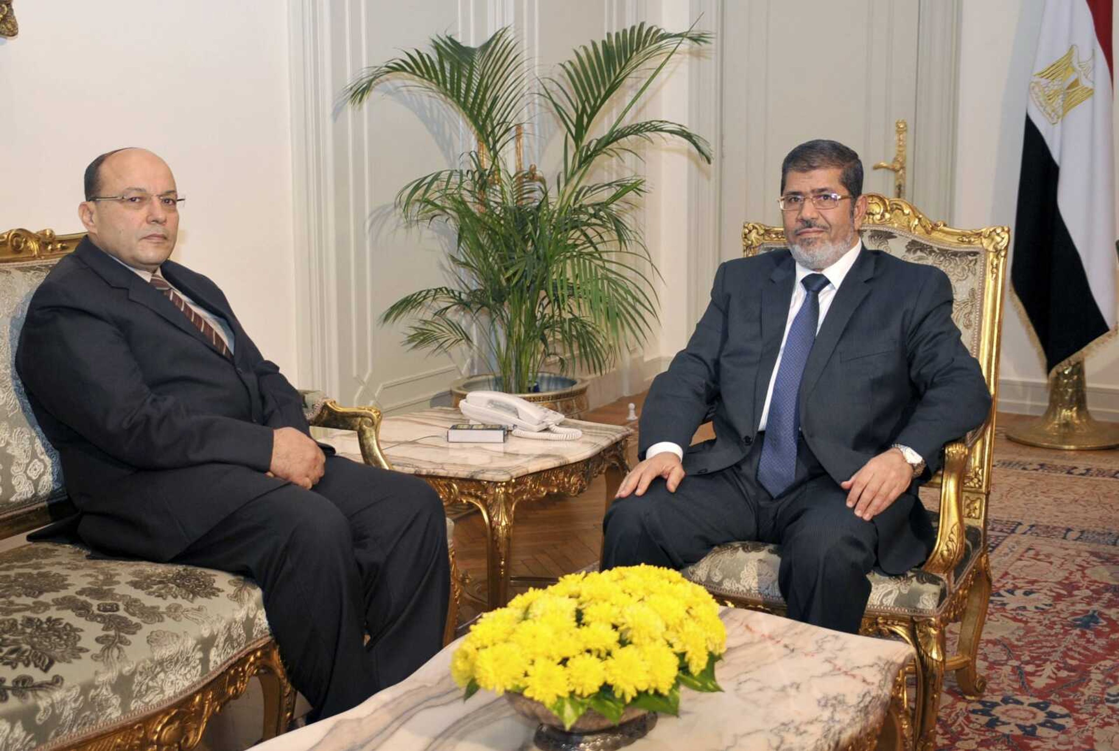 In this photo released by the Egyptian Presidency, President Mohammed Morsi, right, poses for a photograph with his new Prosecutor General, Talaat Abdullah, left, in Cairo, Egypt, Thursday, Nov. 22, 2012. (AP Photo/Egyptian Presidency)