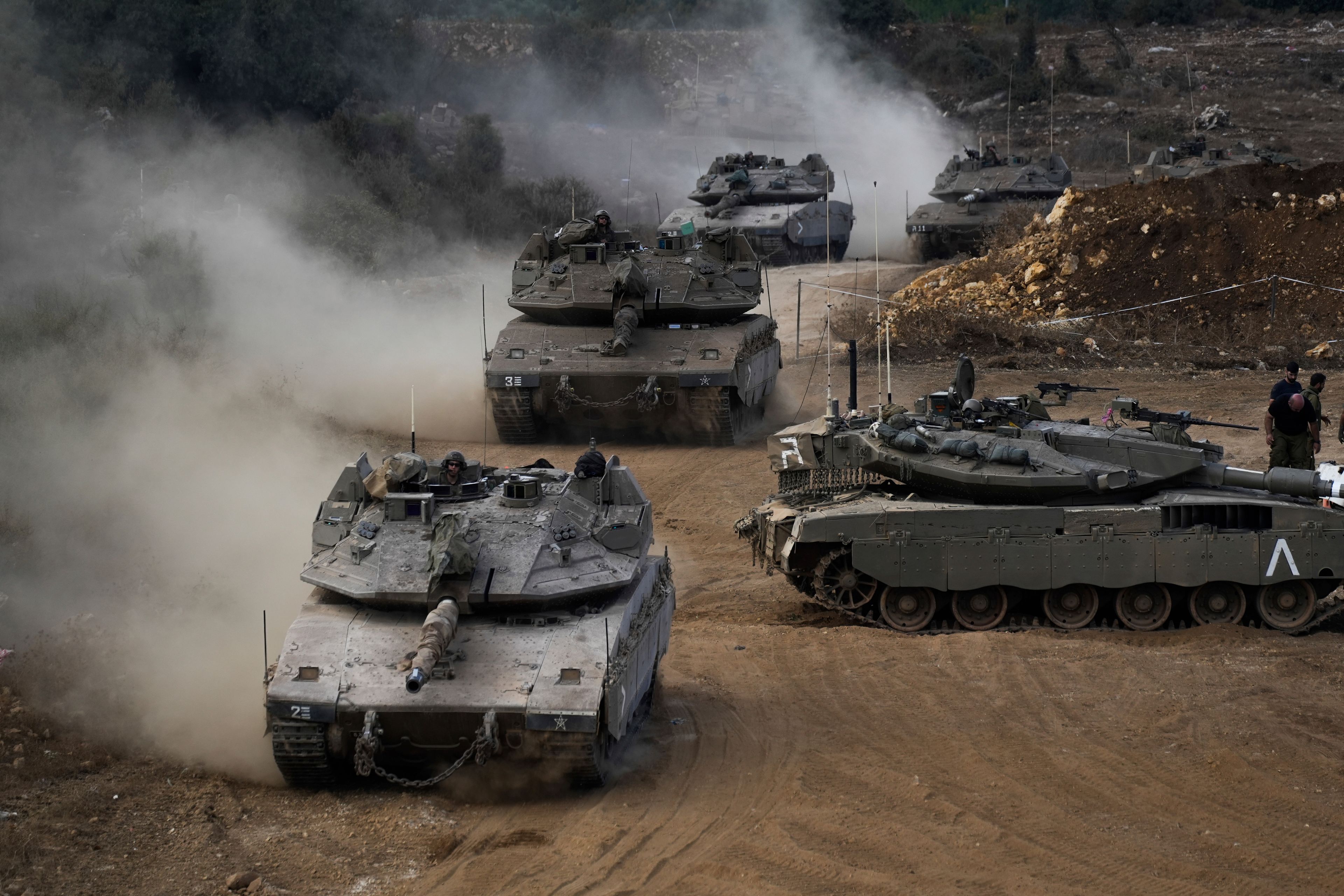 Israeli army tanks maneuver in a staging area in northern Israel near the Israel-Lebanon border, Tuesday, Oct. 1, 2024. (AP Photo/Baz Ratner)