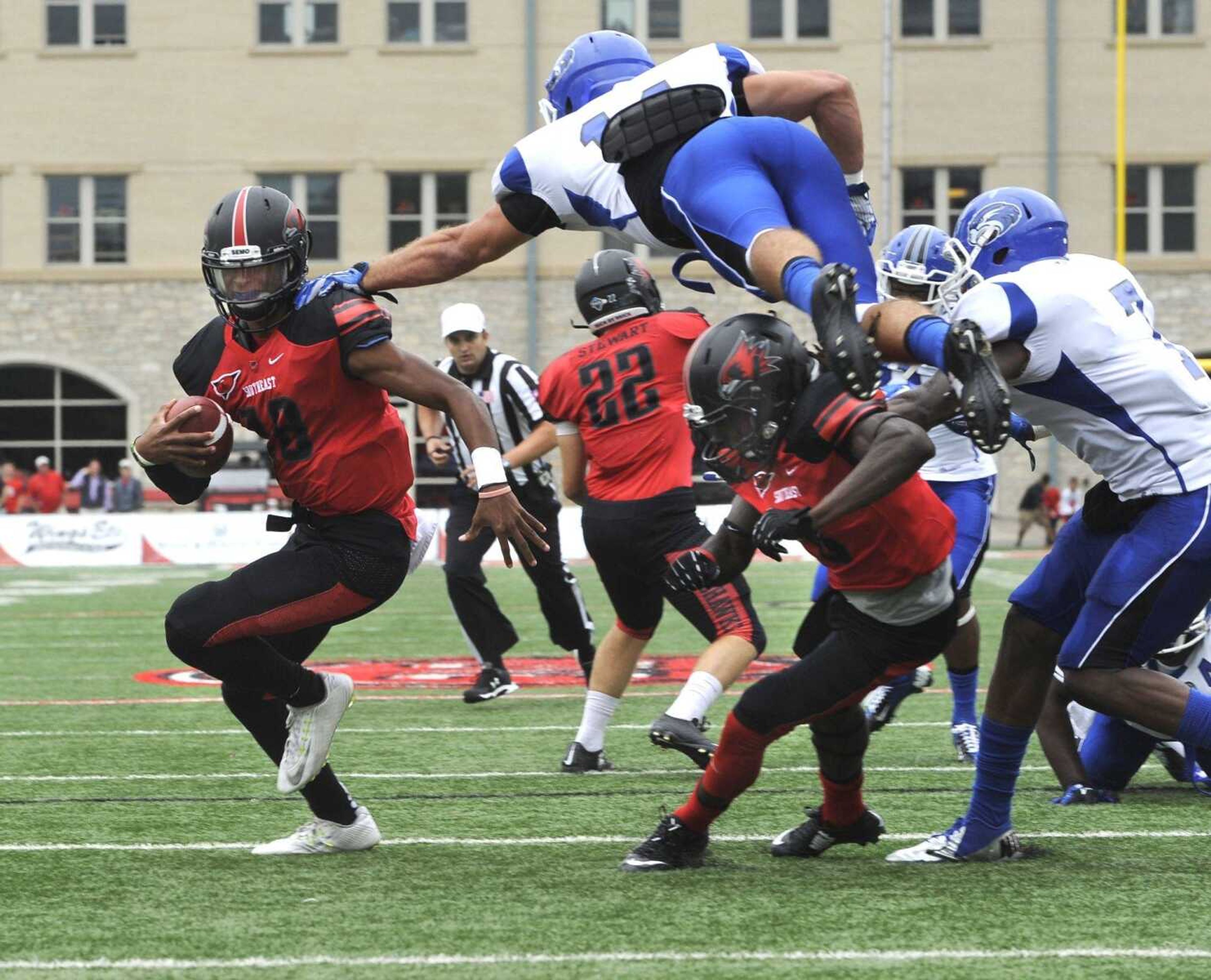 Southeast Missouri State quarterback Dante Vandeven keeps for a 5-yard touchdown run past Shorter defender Jordan Shaw during the first quarter Saturday, Sept. 26, 2015 at Houck Stadium. (Fred Lynch)