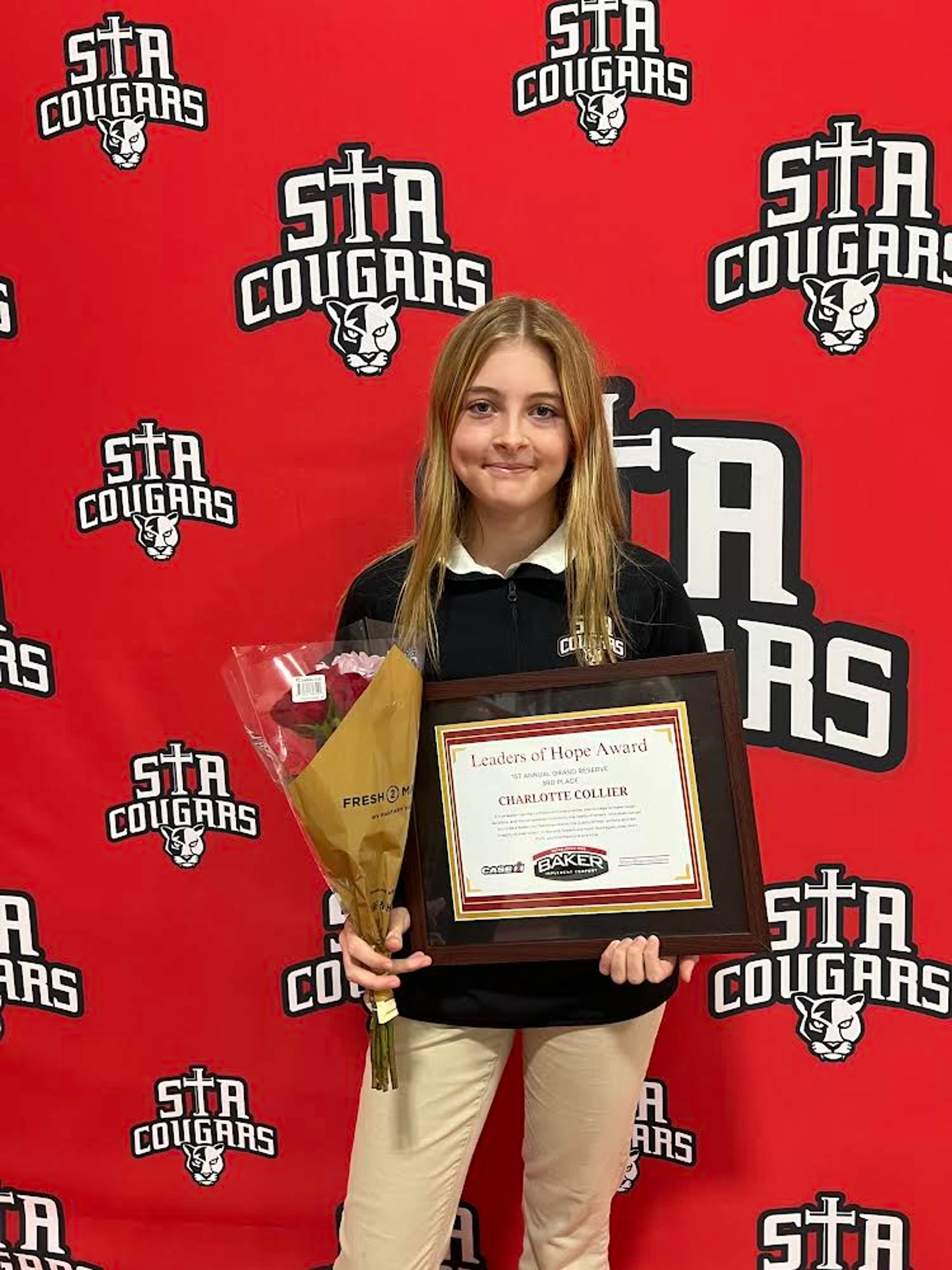 St. Augustine student Charlotte Collier poses for a photo after receiving her Leaders of Hope Award.