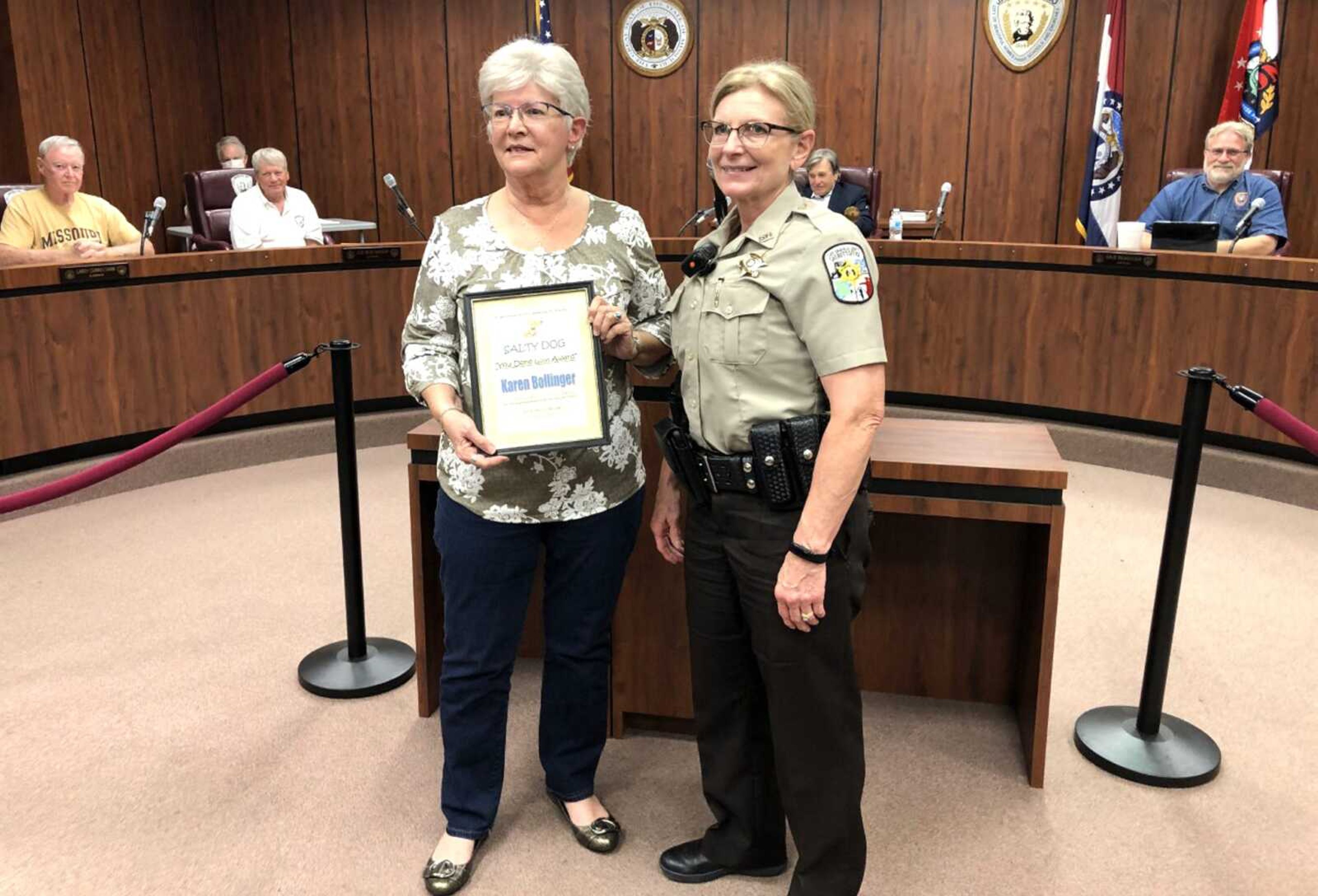 Cape Girardeau County Sheriff Ruth Ann Dickerson, right, presents the county's "Salty Dog" Award to Jackson city employee Karen Bollinger on behalf of S.A.L.T. (Seniors and Lawmen Together) during the Jackson Board of Aldermen meeting Monday night.