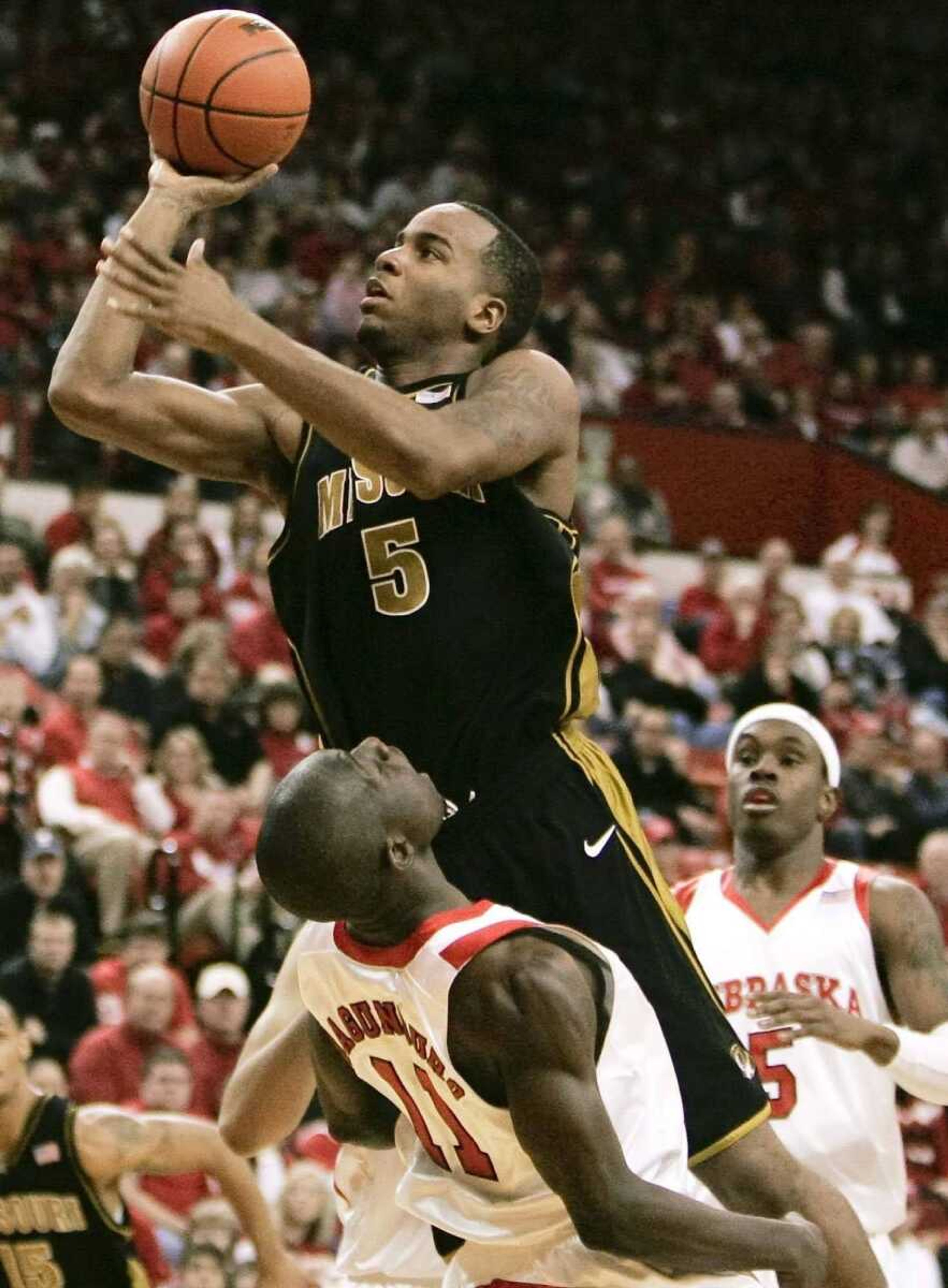 NATI HARNIK ~ Associated Press<br>Missouri's Leo Lyons commits a charge against Nebraska's Ade Dagunduro during Saturday's loss in Lincoln, Neb.