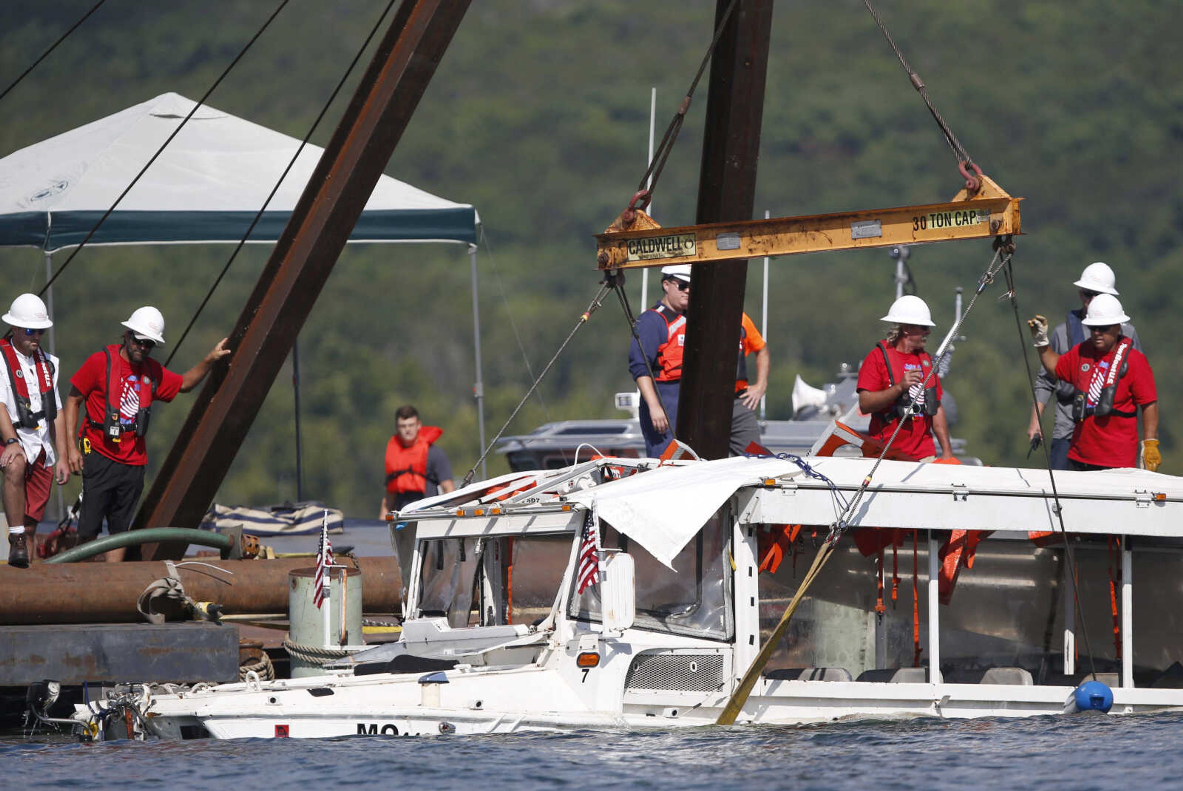 The duck boat that sank in Table Rock Lake in Branson, Missouri, is raised Monday.