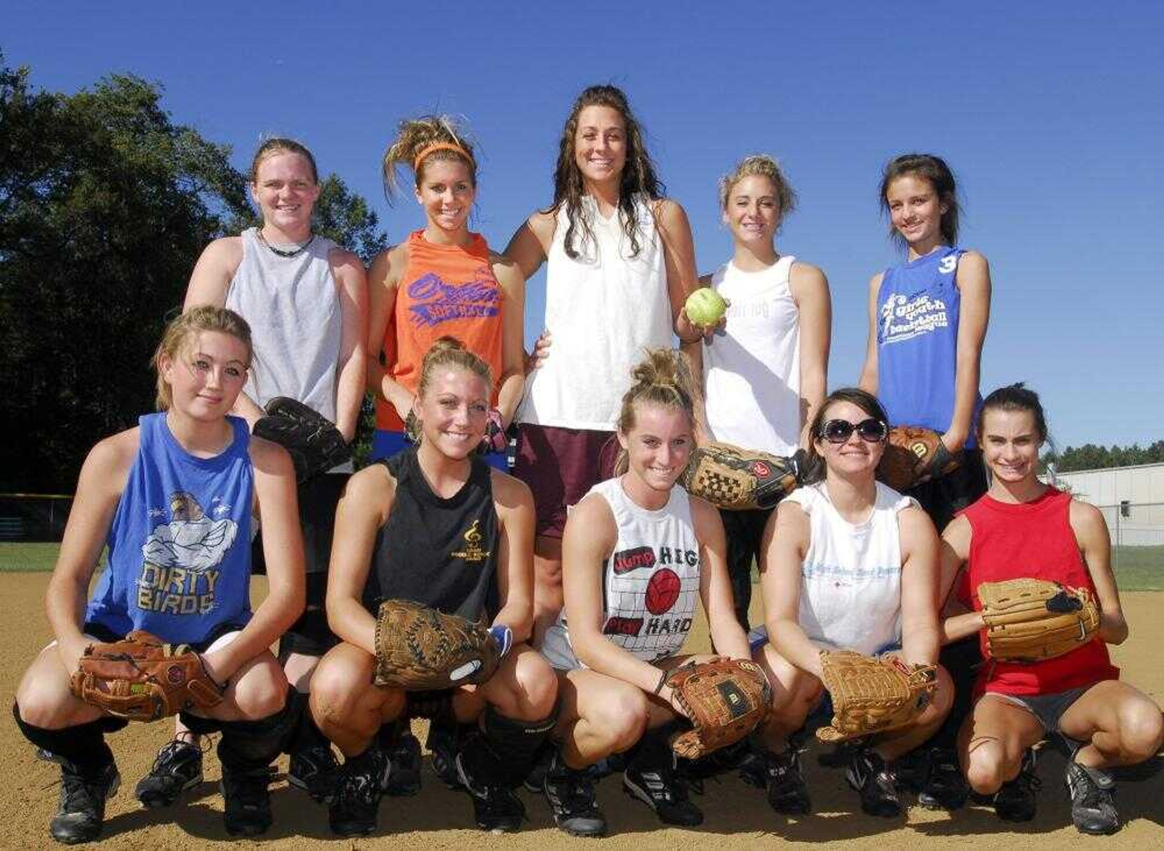 Oran softball and volleyball coach Sara Heisserer posed with members of her softball team who play both sports at Oran. From left, front row: Cheyanne King, Cassie Graviett, Alyson Seyer, Katey Tilley and Shelbie Seyer; back row: Taylor Irwin, Callie Kielhofner, Heisserer, Taylor Tenkhoff and Roxanne Walter. (Fred Lynch)