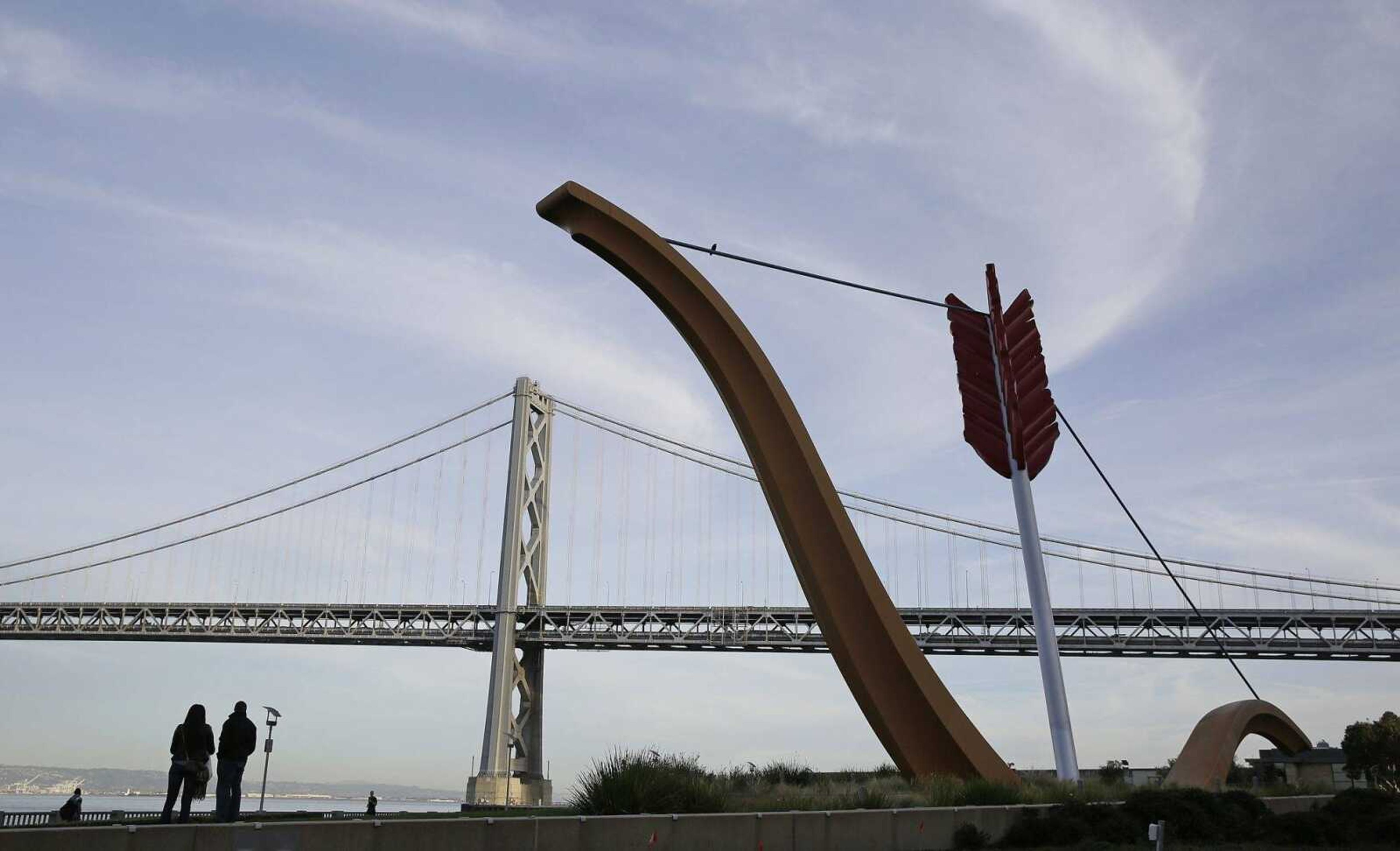 In this photo, a couple looks up at the San Francisco-Oakland Bay Bridge while standing by the sculpture, Cupids Span, in San Francisco. Celebrating your 25th anniversary in a meaningful way doesn't require big expenditures or elaborate staging, says Pepper Schwartz, a University of Washington-Seattle sociologist who also works as the AARP's relationship expert. (AP Photo/Eric Risberg)