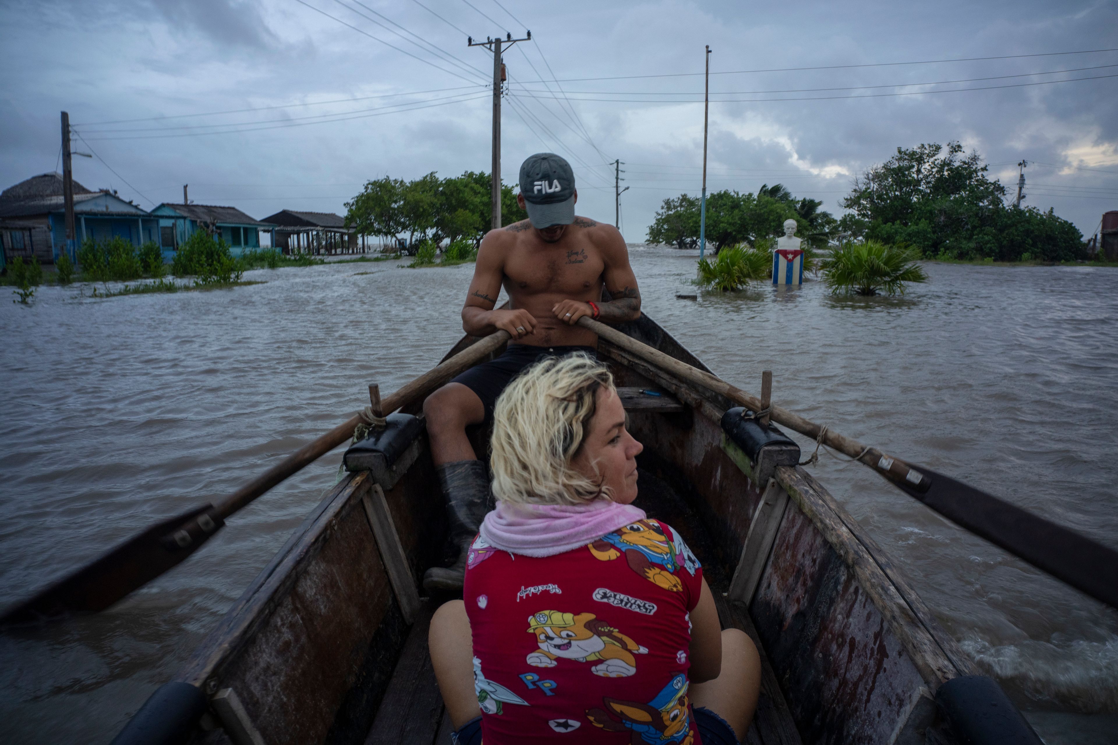 People traverse a flooded street on a boat after the passage of Hurricane Helene in Guanimar, Artemisa province, Cuba, Wednesday, Sept. 25, 2024. (AP Photo/Ramon Espinosa)