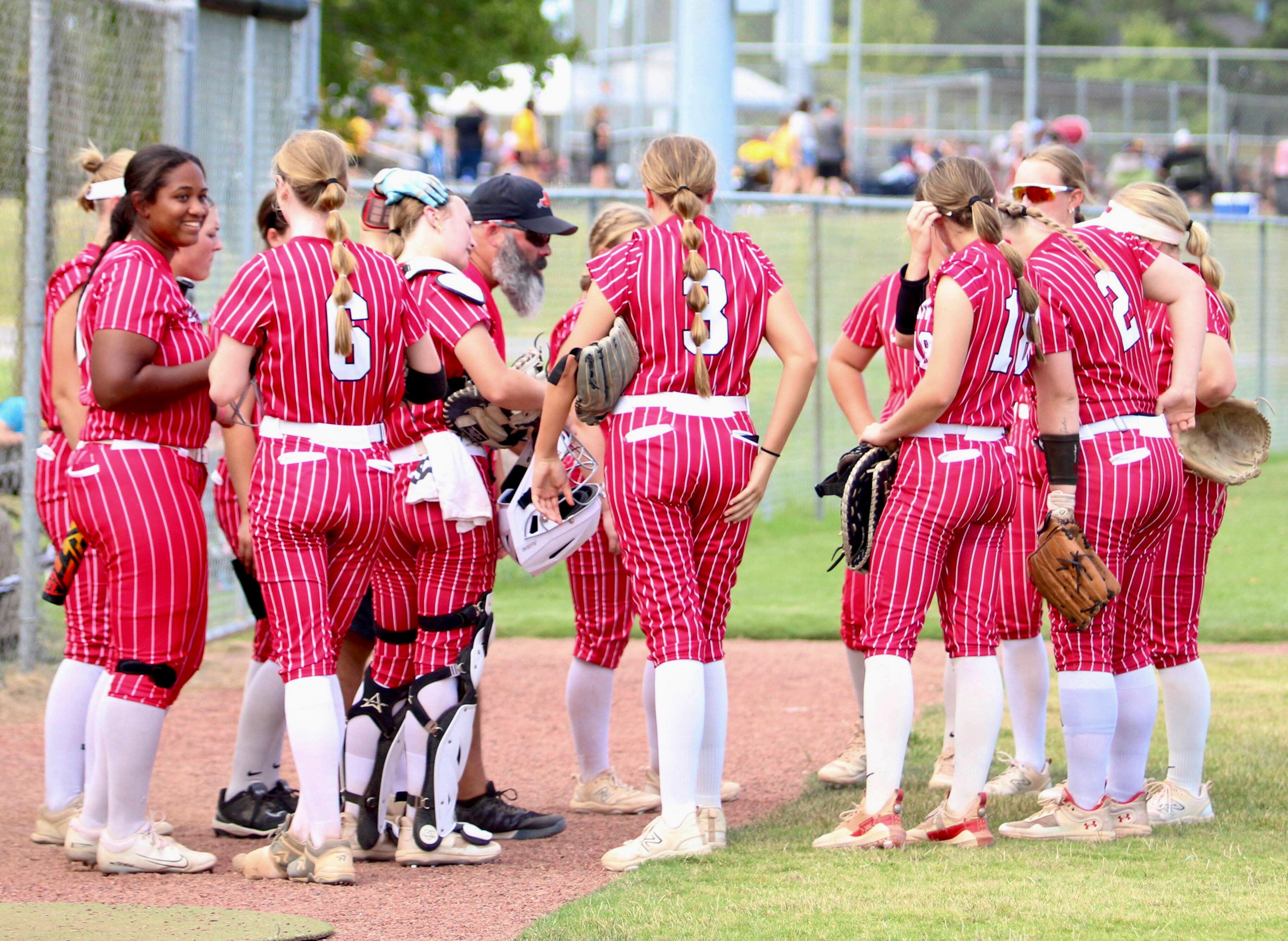 Jackson head coach Shawn Wilding talks to his team before their Jackson Invitational Softball Tournament game on Saturday, Aug. 31, in Jackson, Mo. 
