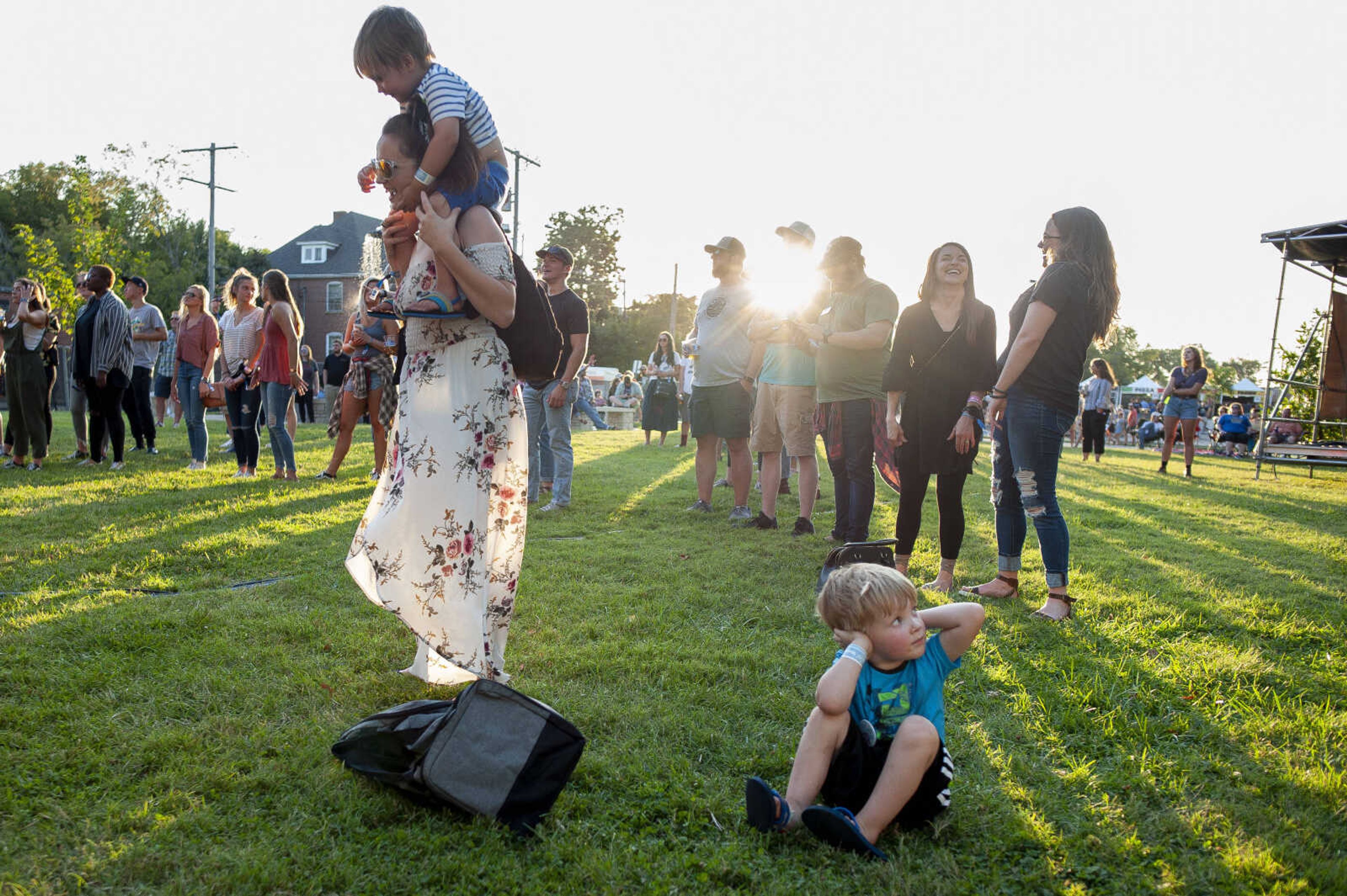 Mylez Garms, 5, puts his hands over his ears near his mother Hayley Pobst of Cape Girardeau, holding Gabriel Pobst, 3, as Retro City performs during Shipyard Music and Culture Festival on Friday, Sept. 27, 2019, in Cape Girardeau.