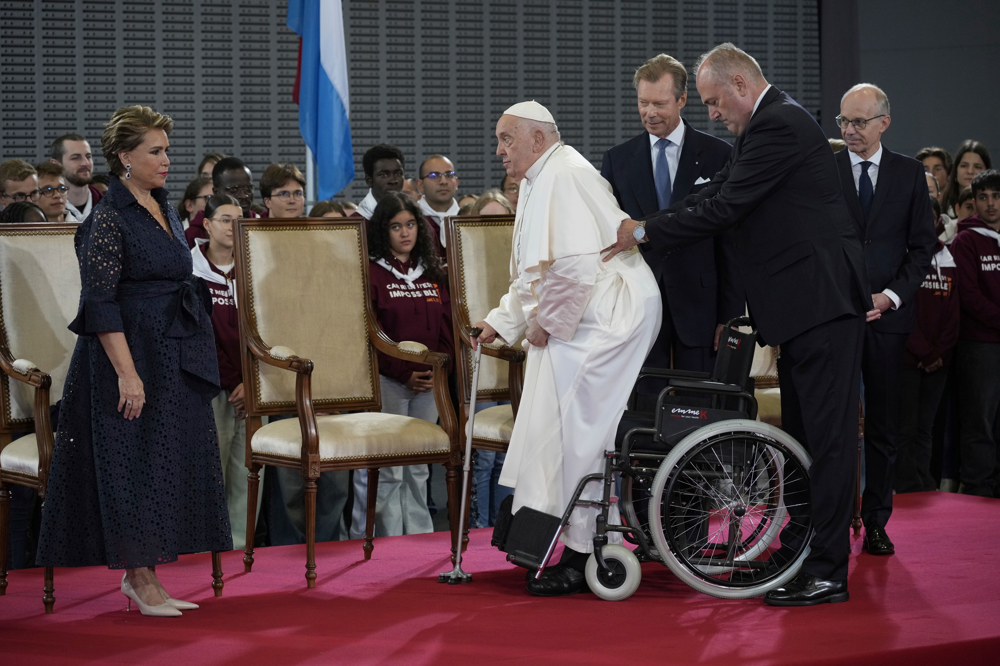 Pope Francis flanked by Grand Duchess Maria Teresa, left, Luxembourg's Grand Duke Henri, second form right, and by the Prime Minister Luc Friede attends the welcome ceremony upon his arrival at Findel International Airport in Luxembourg, Thursday, Sept. 26, 2024. (AP Photo/Andrew Medichini)