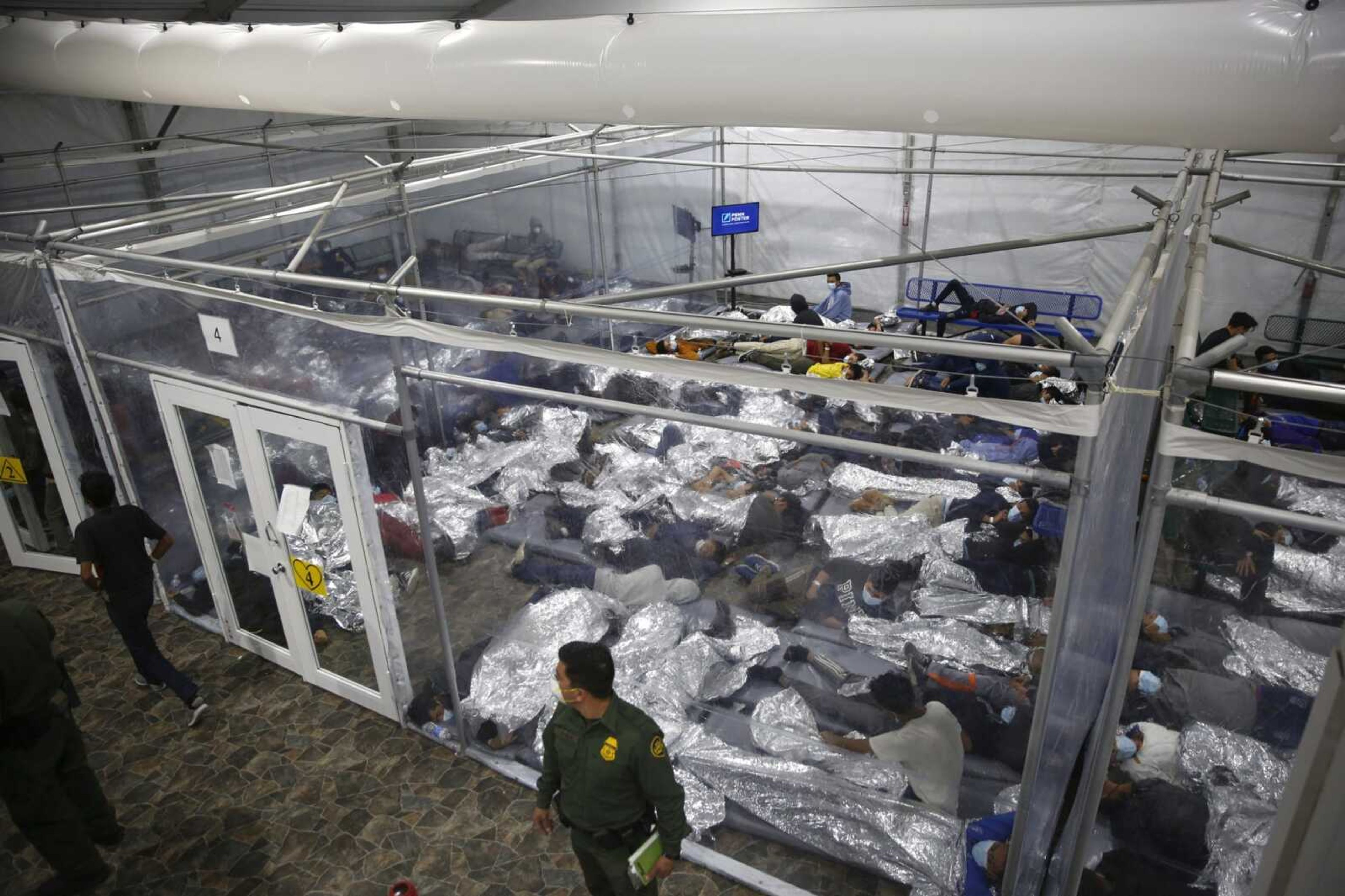 Young minors lie inside a pod at the Donna Department of Homeland Security holding facility, the main detention center for unaccompanied children in the Rio Grande Valley run by U.S. Customs and Border Protection, on March 30 in Donna, Texas.