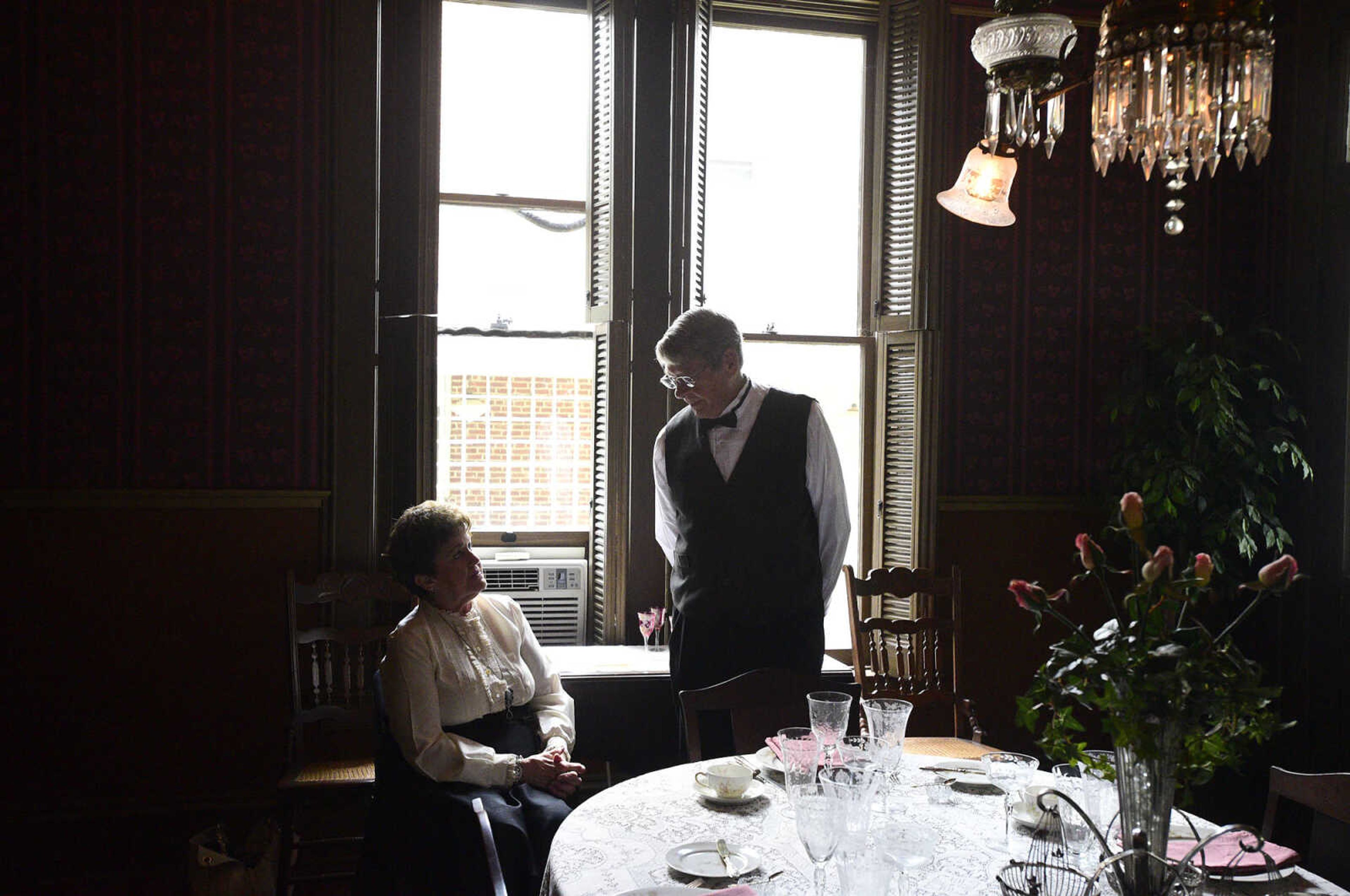 Mary Lou Bass and her husband Tom, dressed in period costume, visit inside the Glenn House dining room on Wednesday, Aug. 16, 2017, in Cape Girardeau. KMOS-TV, a PBS affiliate, was filming inside the historic home for its Missouri Life show.