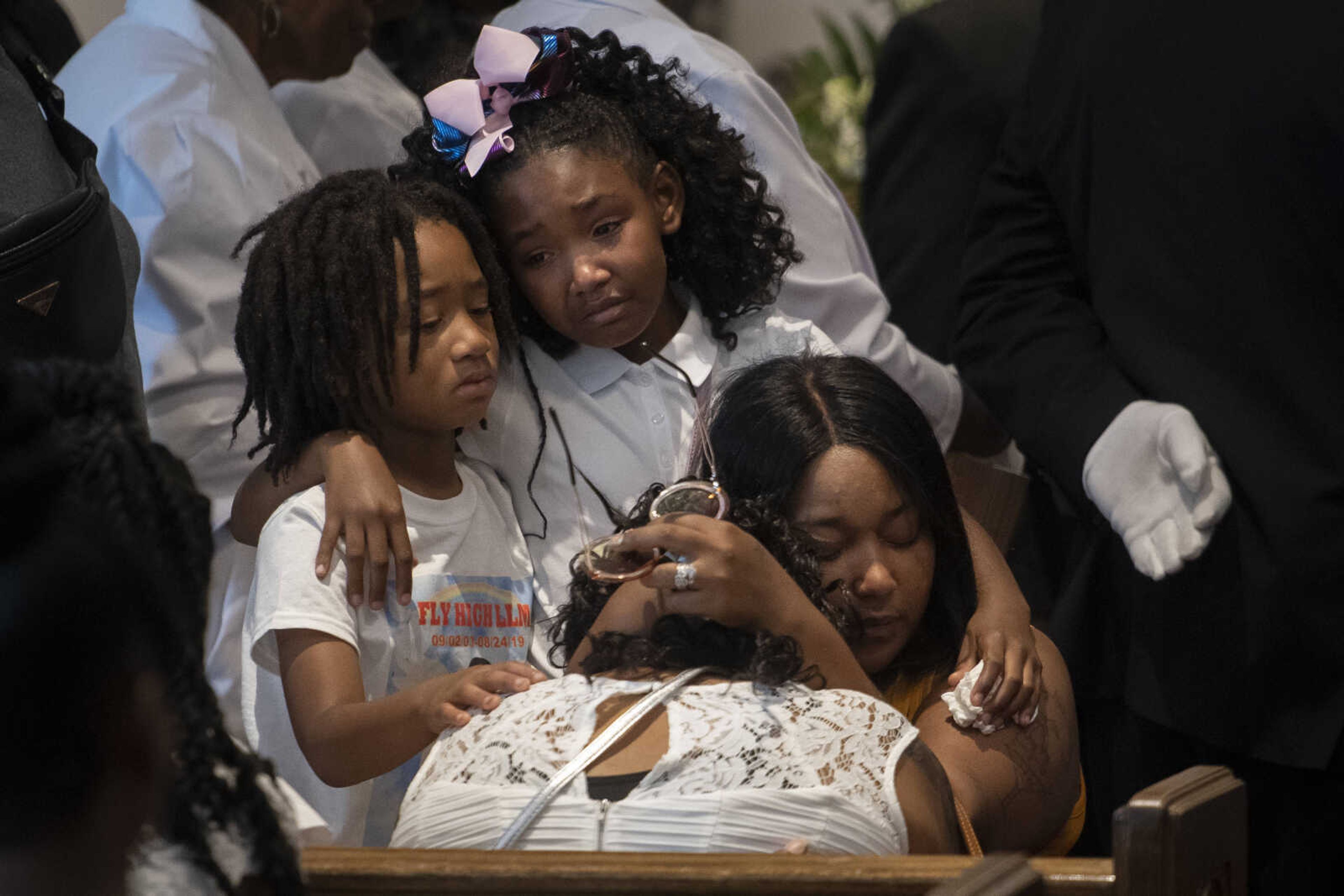 Monday was 16 years since the birth of Madison Robinson; Tuesday was her funeral. Robinson died after being shot Aug. 24 on the front porch of her Cape Girardeau home. Scores turned out for Robinson's visitation and funeral Sept. 3, 2019, at Mercy Seat Missionary Baptist Church in Charleston, Missouri. "I'll have people remember this day, today, that a 15-year-old girl is dead in our community," Robinson's cousin Alex Gilbert said. "If you want to remember her, remember her as somebody that shouldn't have died because of the gun violence." Pictured from left: Sunnyboy Mims, 7, and Randi Jones, 9, cousins of Robinson; and Misty Robinson, aunt of Madison, mourn with Martez Johnson (Madison's aunt who raised her), with head bowed, during Madison's services.