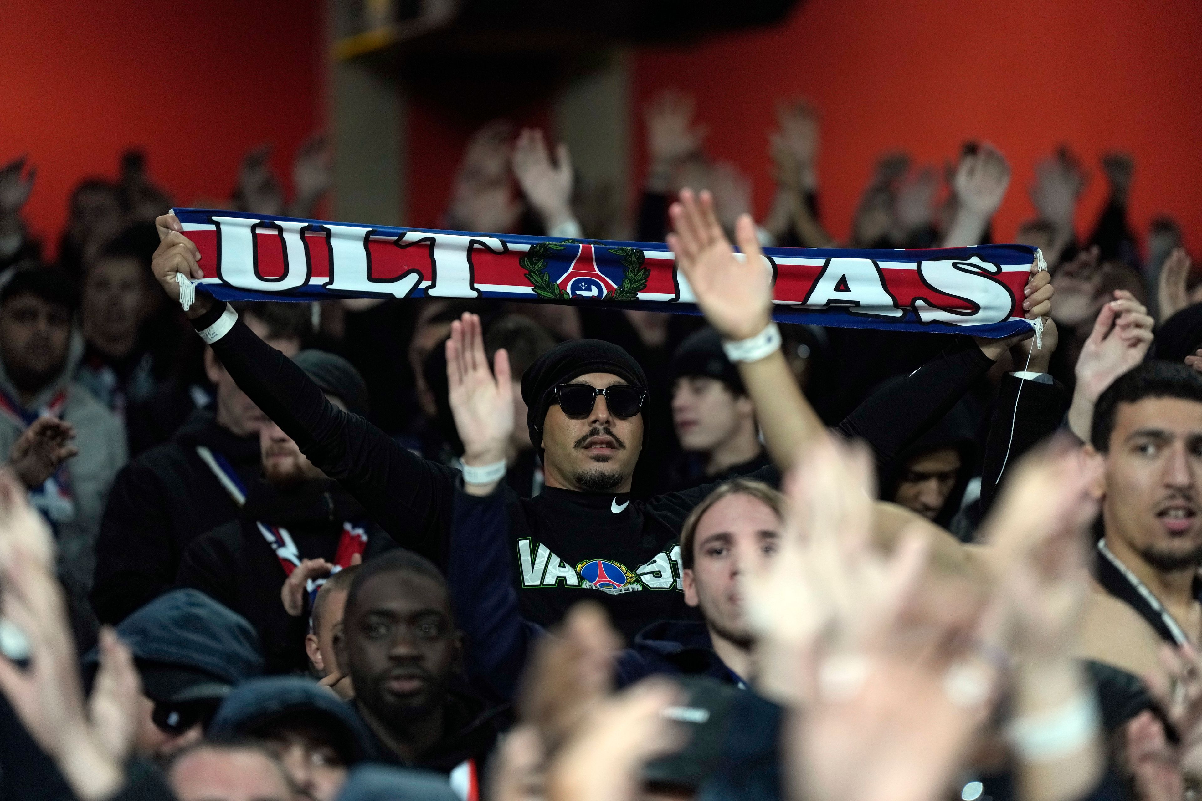 PSG fans cheer on the stands before the start of a Champions League opening phase soccer match between Arsenal FC and Paris Saint-Germain at Arsenal stadium in London, England, Tuesday, Oct. 1, 2024. (AP Photo/Alastair Grant)