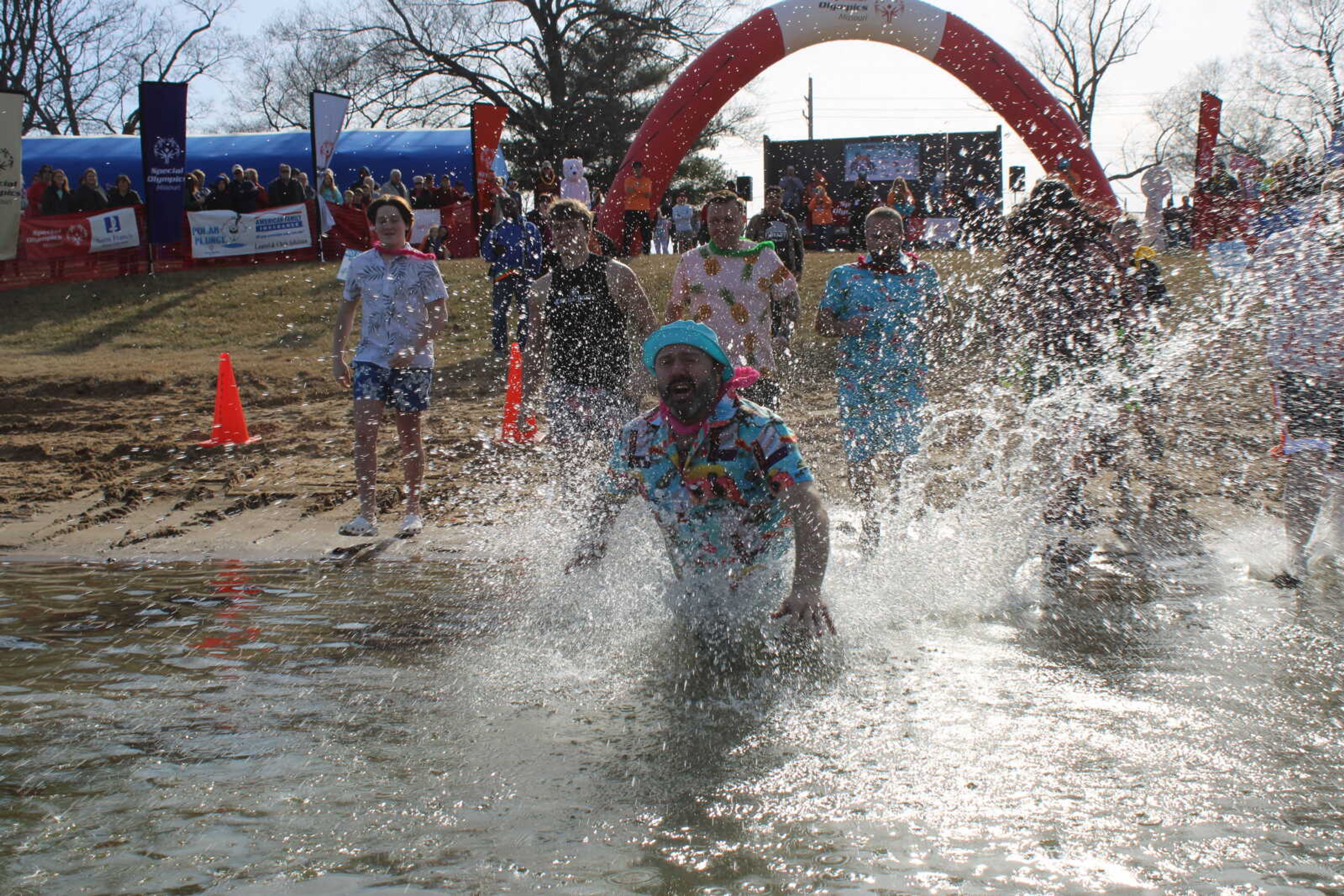 Member of the "Copsicles" dives into the pond during the Polar Plunge on Feb. 3