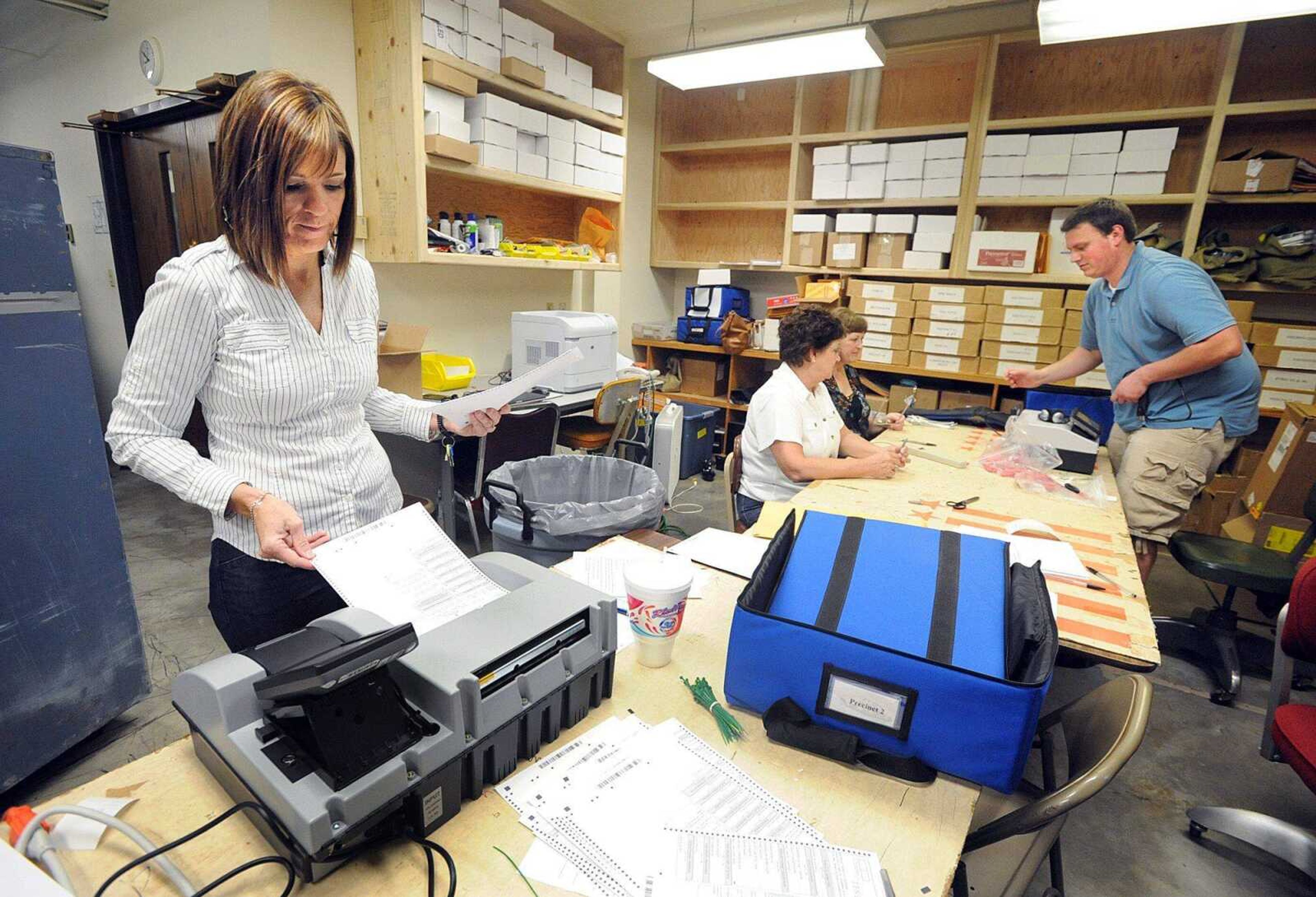 Cape Girardeau County Clerk Kara Clark Summers tests the automatic tabulating equipment Tuesday morning, July 24, 2012 at the County Administration Building in Jackson. The equipment is being tested in preparation for the Aug. 7 primary election. Registered voters have until election day to change their address on their registration. (Laura Simon)