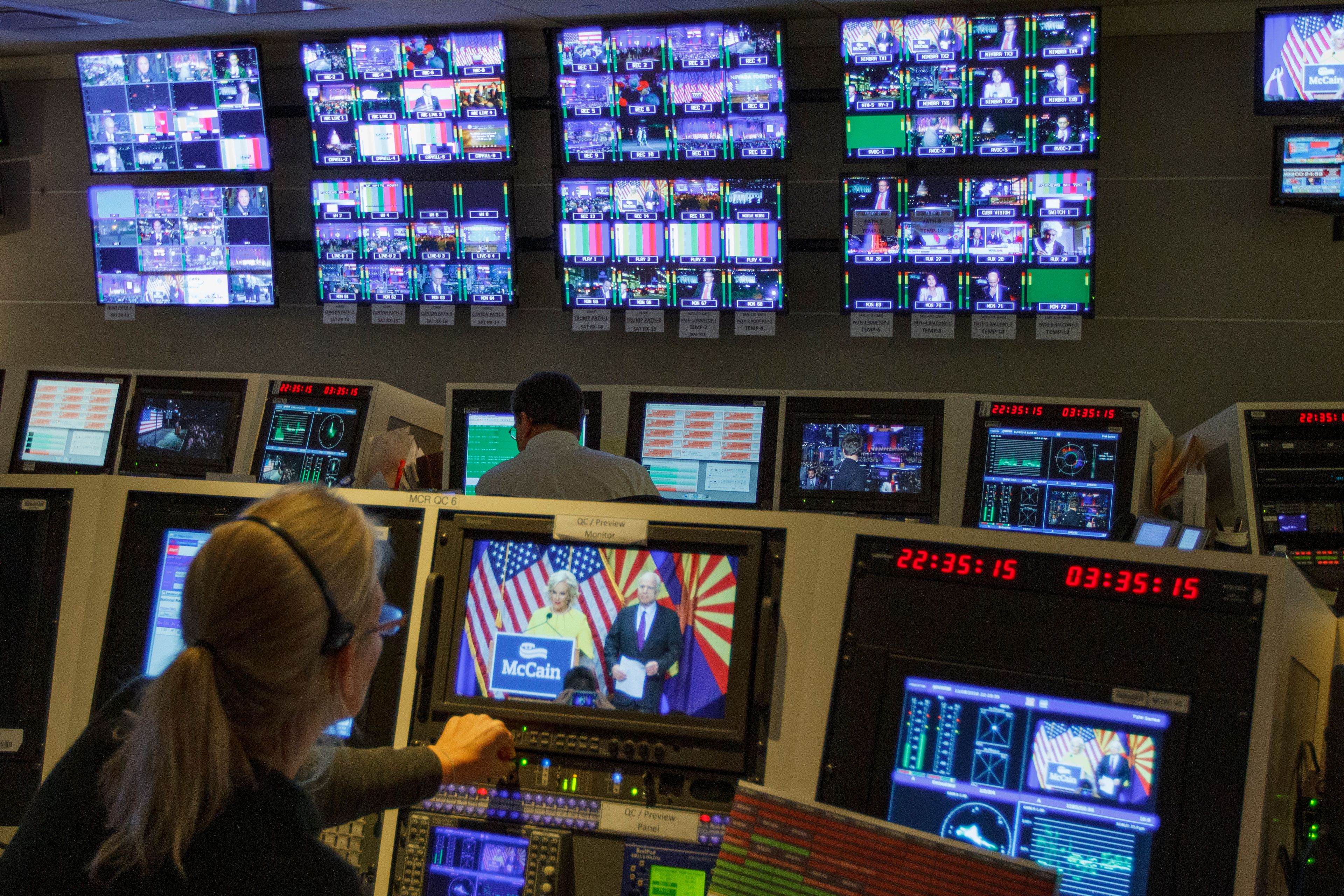 FILE - Staff members of The Associated Press Television Network work in master control at the Washington bureau of The Associated Press in Washington, Nov. 8, 2016, as returns come in during election night. (AP Photo/Jon Elswick)