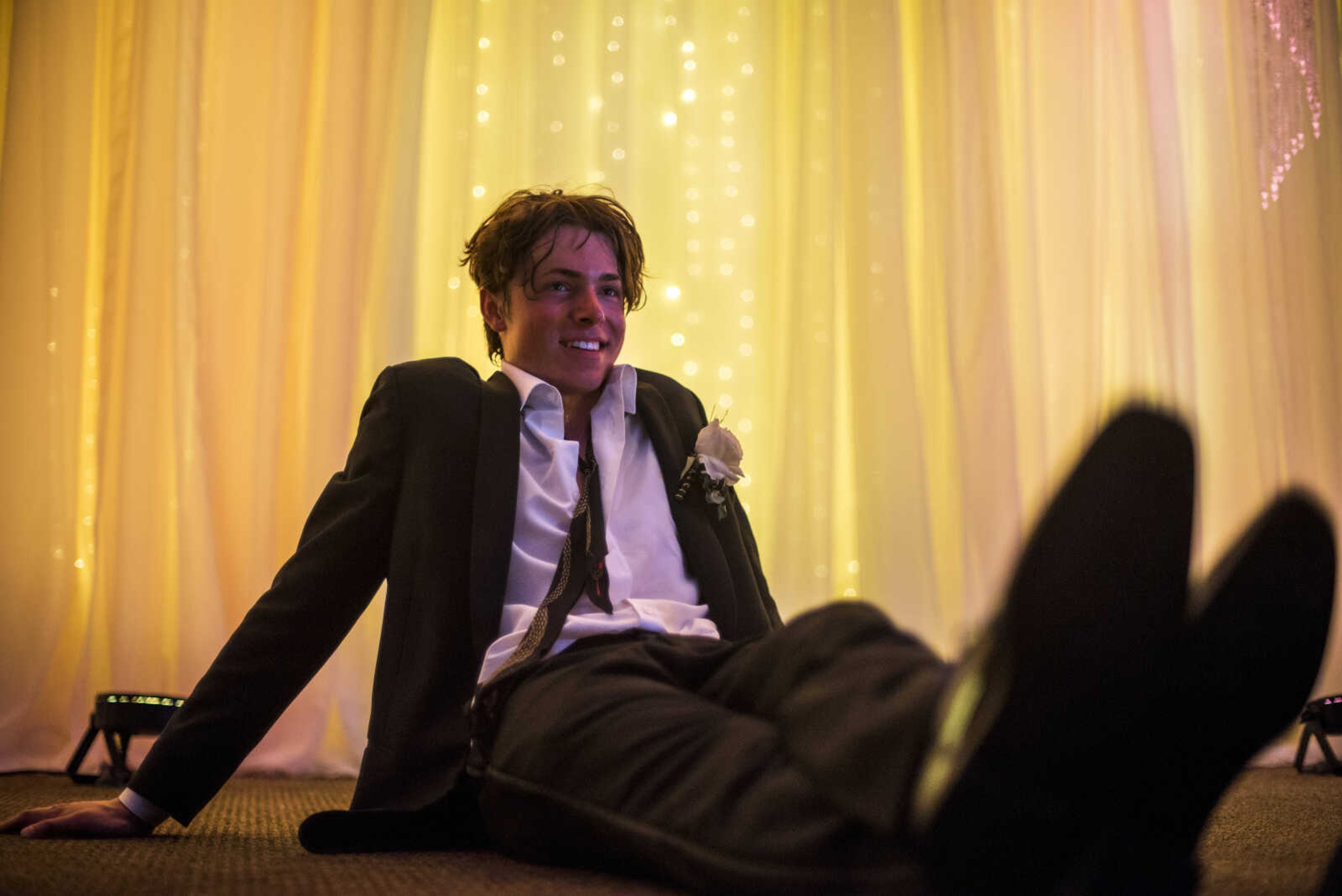 Jared Neikirk takes a breather near the dance floor during Cape Central High School Prom Saturday, April 27, 2019, at Ray's Banquet Center in Cape Girardeau.