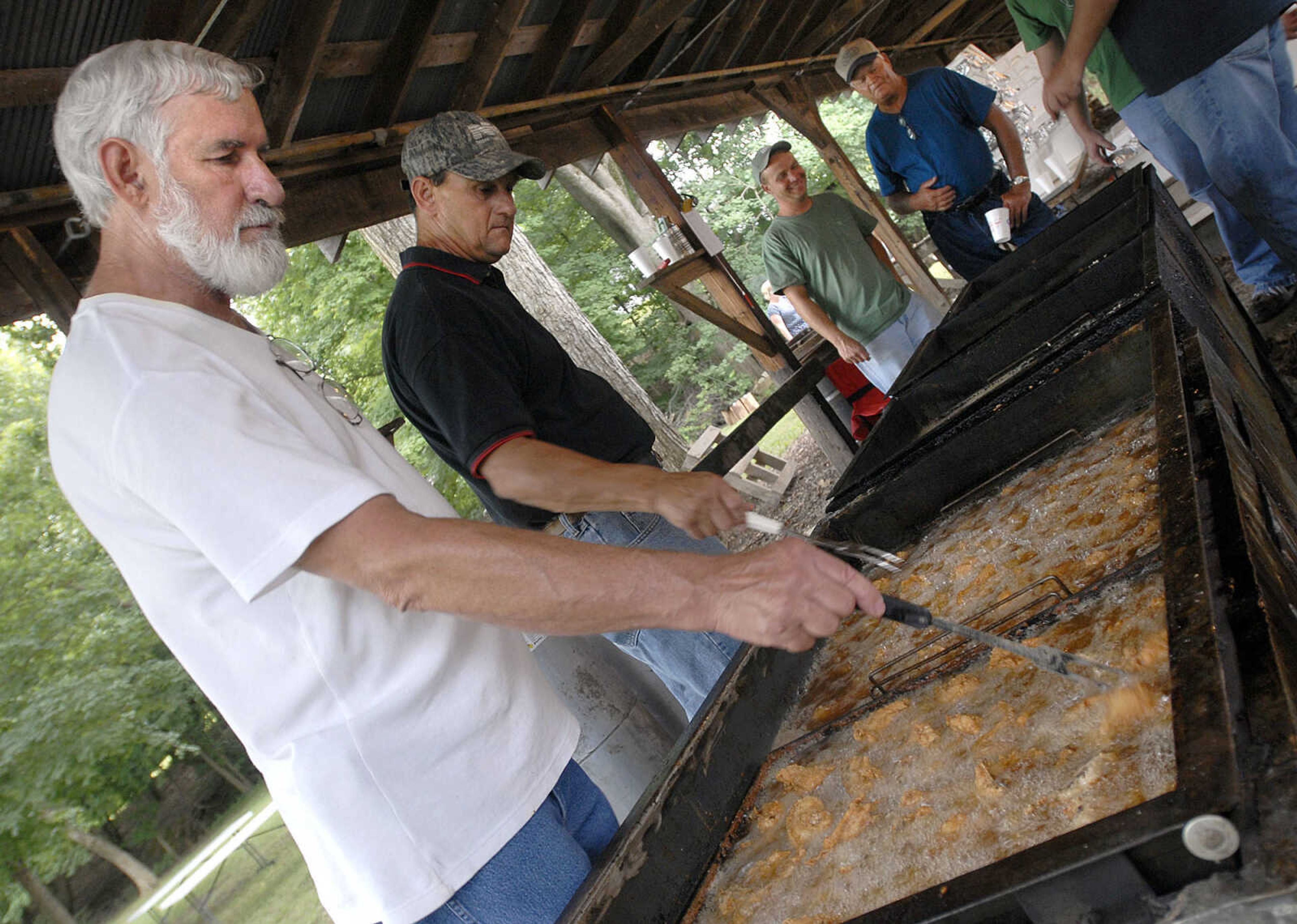 FRED LYNCH ~ flynch@semissourian.com
Al Forrester, left, and Ronnie Wesbecher cook chicken for the Leopold Picnic Saturday. Over 1,500 lbs. of chicken was prepared for the hungry patrons.