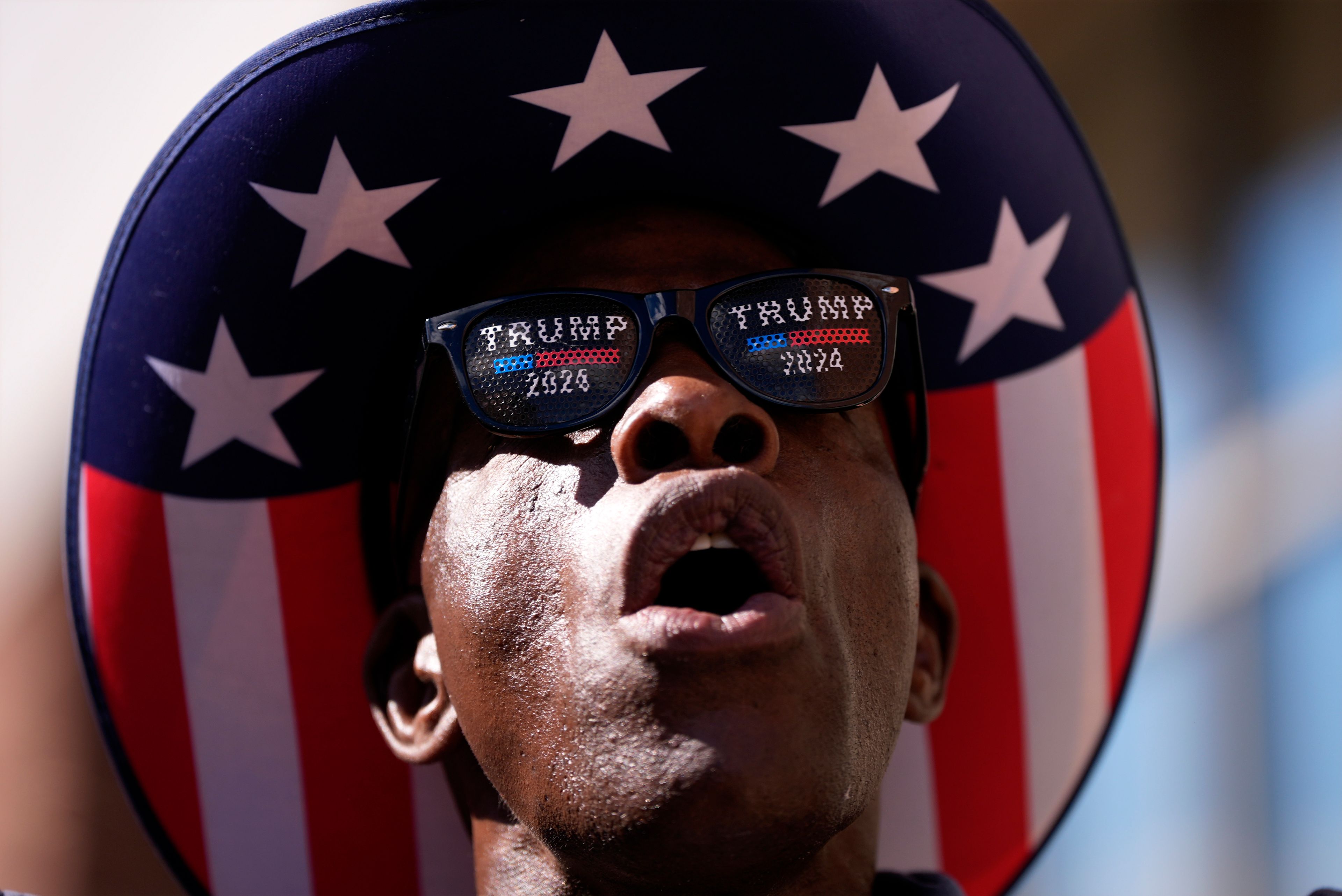 A supporter yells at reporters while waiting to attend a campaign rally with Republican presidential nominee former President Donald Trump at Santander Arena, Wednesday, Oct. 9, 2024, in Reading, Pa. (AP Photo/Matt Slocum)