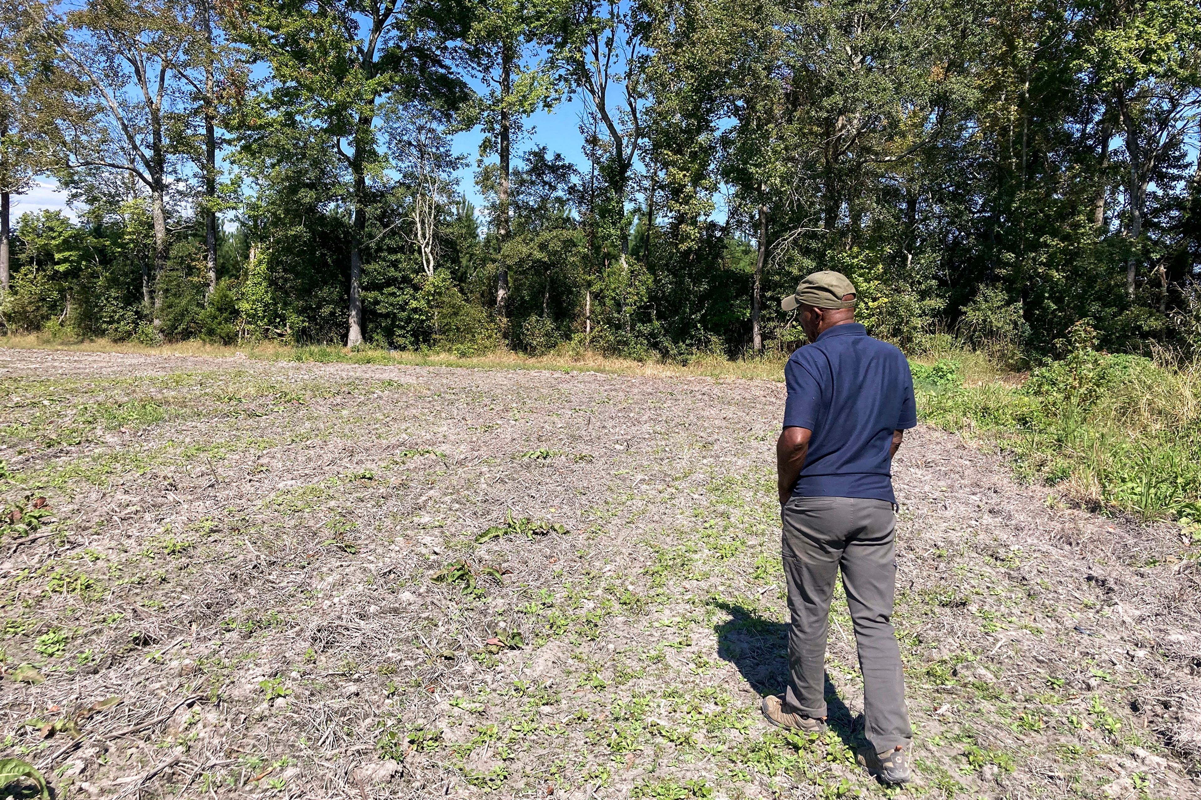 Rev. Richard Joyner walks through a field flooded by Hurricane Helene in Conetoe, N.C., Oct. 14, 2024. (Yonat Shimron/Religion News Service via AP)