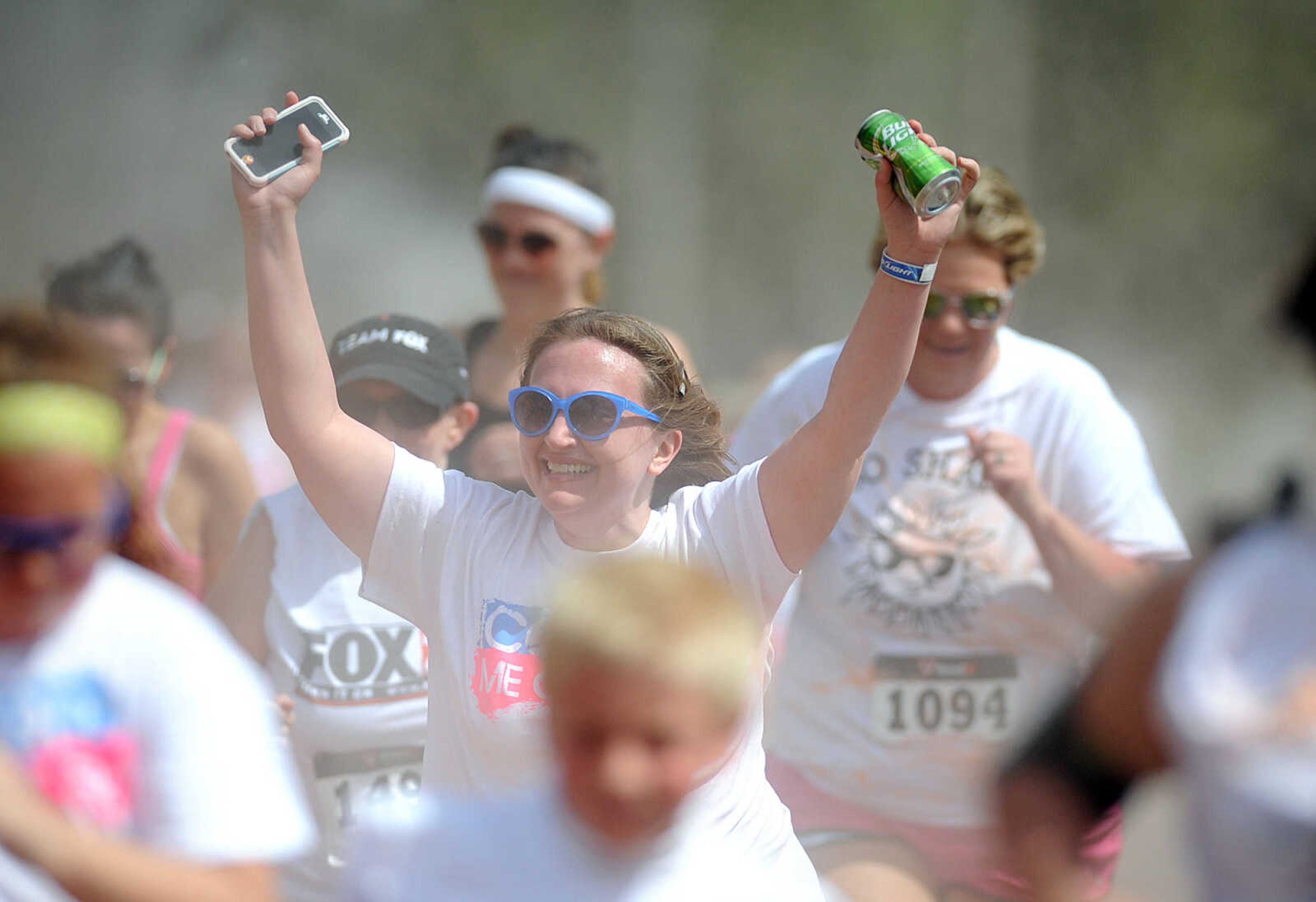 LAURA SIMON ~ lsimon@semissourian.com

Participants in the Color Me Cape 5K are sprayed with orange powder at the first color station on Good Hope Street, Saturday, April 12, 2014, in Cape Girardeau.