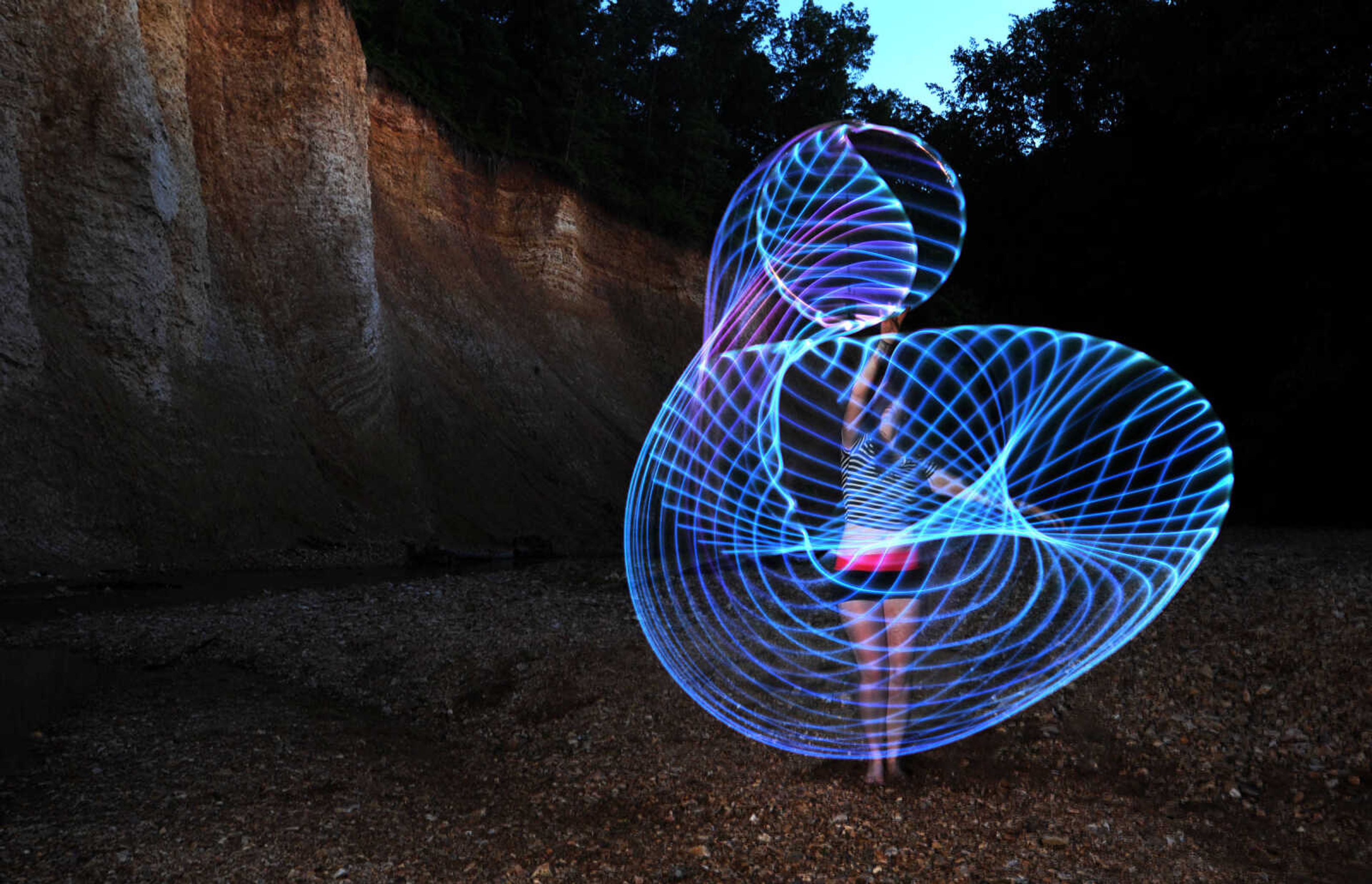 LAURA SIMON ~ lsimon@semissourian.com

Chelsie Welker hoop dances with an LED hoop in a Cape Girardeau County creek, Tuesday, May 26, 2015.