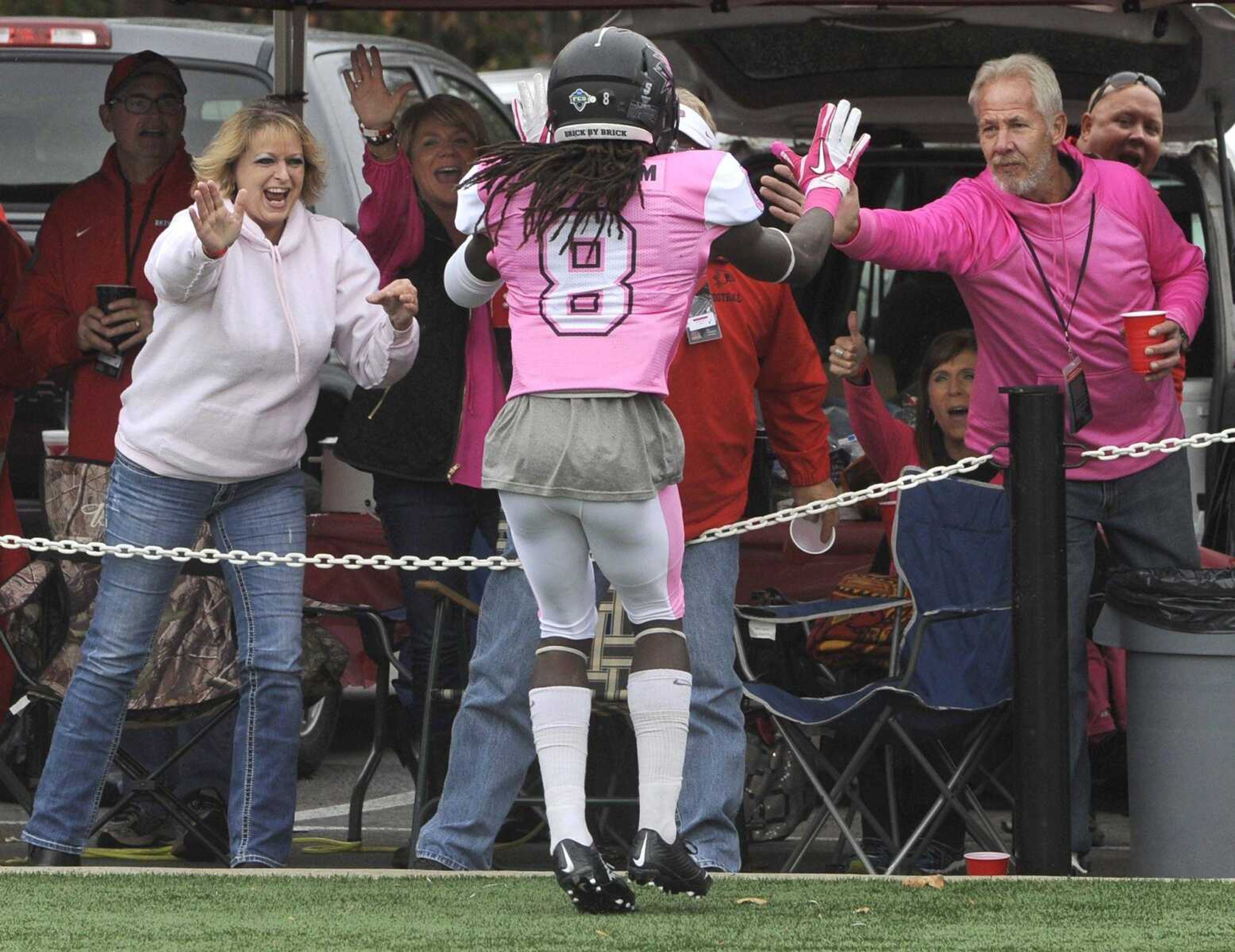 Southeast Missouri State's Tremane McCullough celebrates with Redhawks fans after his 81-yard touchdown run against Tennessee Tech during the first quarter Saturday, Oct. 31, 2015 at Houck Stadium. Officials called a penalty on McCullough for unsportsmanlike conduct by making contact with fans. (Fred Lynch)