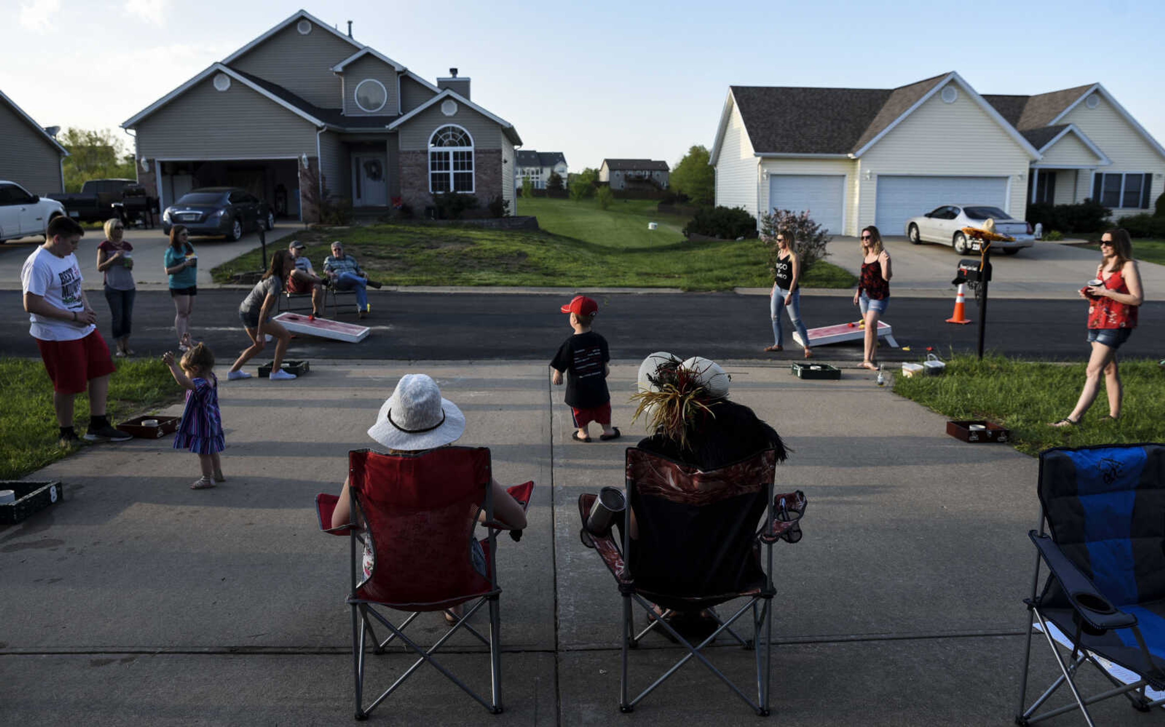 Izaac Pursley, center, stands amidst a corn hole tournament during a neighborhood Cinco de Mayo party May 5, 2018, in Jackson.