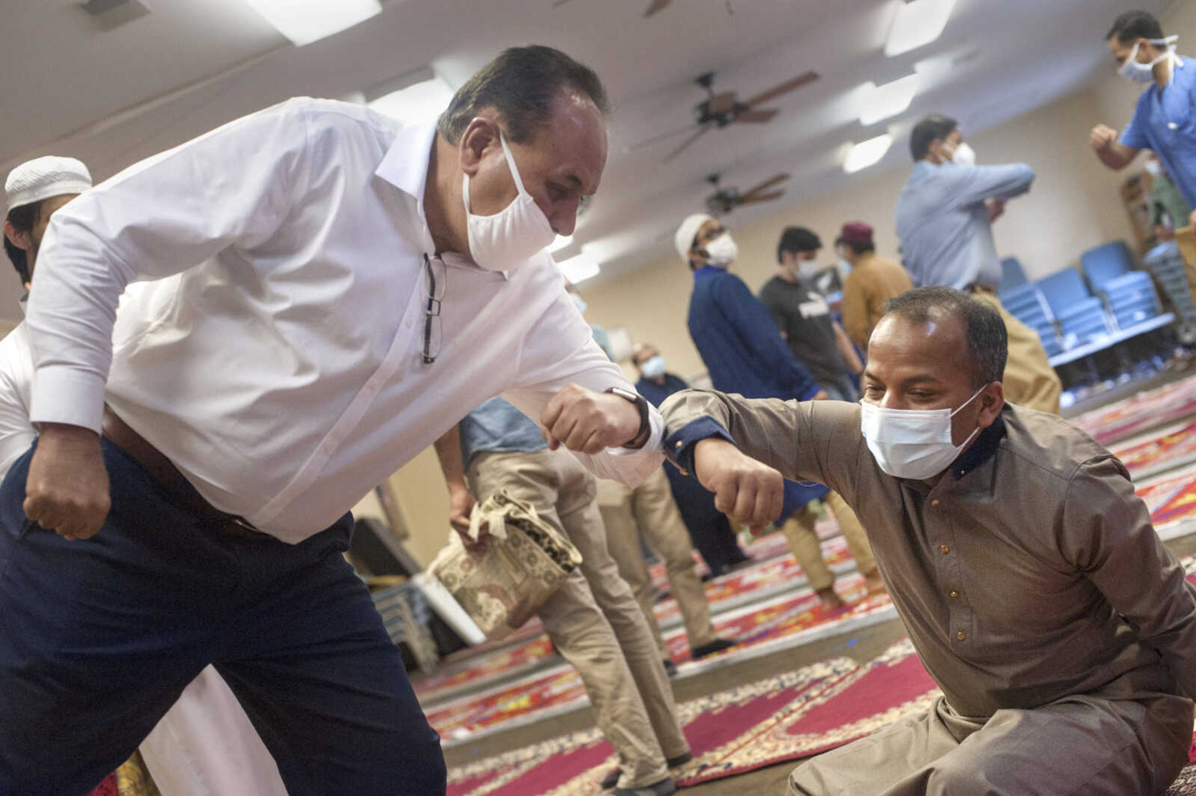 Shafiq Malik, left, bumps elbows with Anisur Rahman after celebrating Eid al-Fitr, a day of celebration marking the end of Ramadan, on Sunday, May 24, 2020, in Cape Girardeau. Traditionally, the celebration would conclude with community members exchanging hugs and partaking in a potluck brunch, but the local Muslim community was unable to do so this year due to the pandemic.