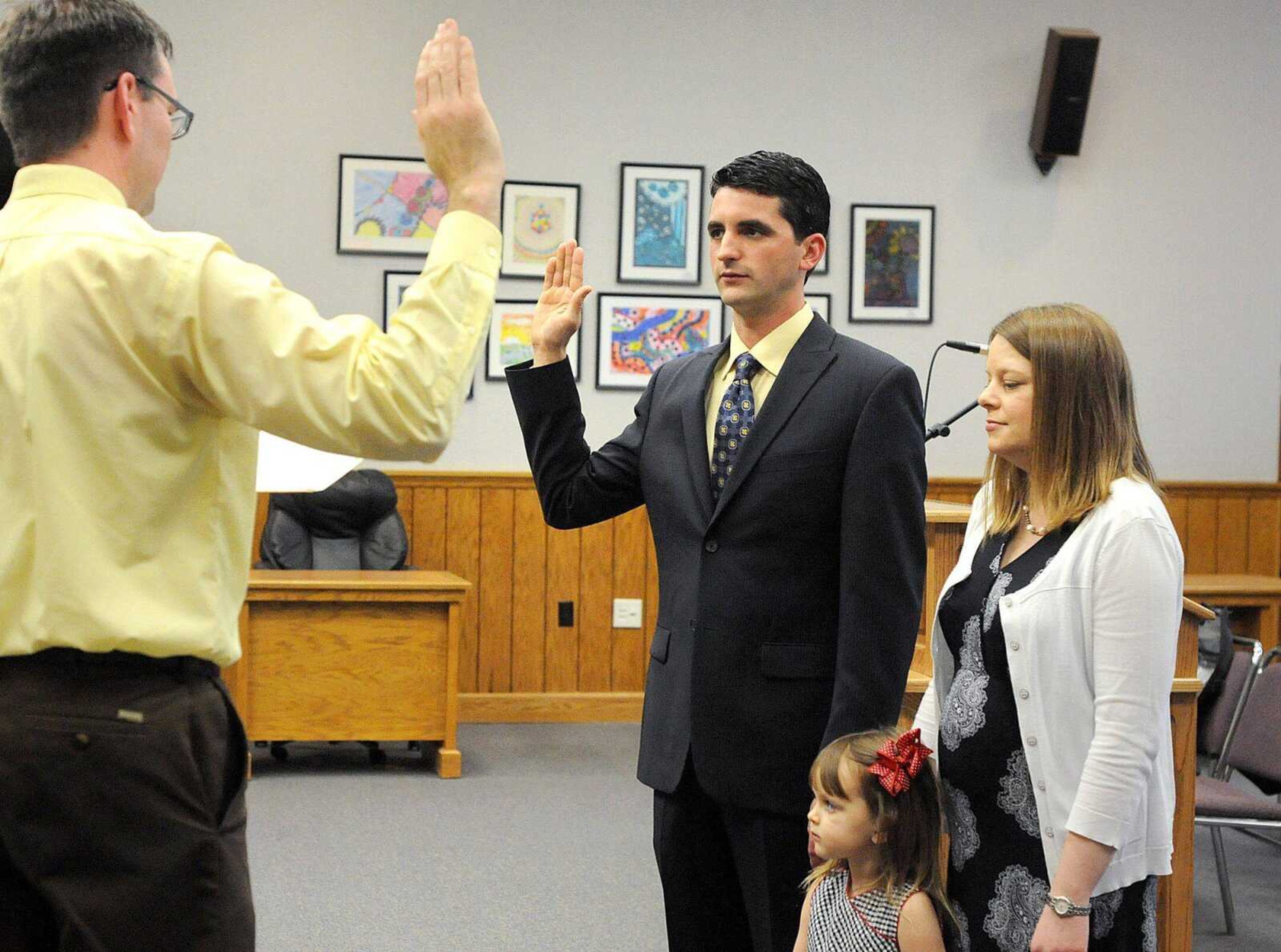 Joseph Uzoaru is accompanied by his wife, Darcy, and daughter Jadie, as he is sworn in as the new Ward 1 Cape Girardeau city councilman by deputy city clerk Bruce Taylor on Monday at city hall. (Laura Simon)