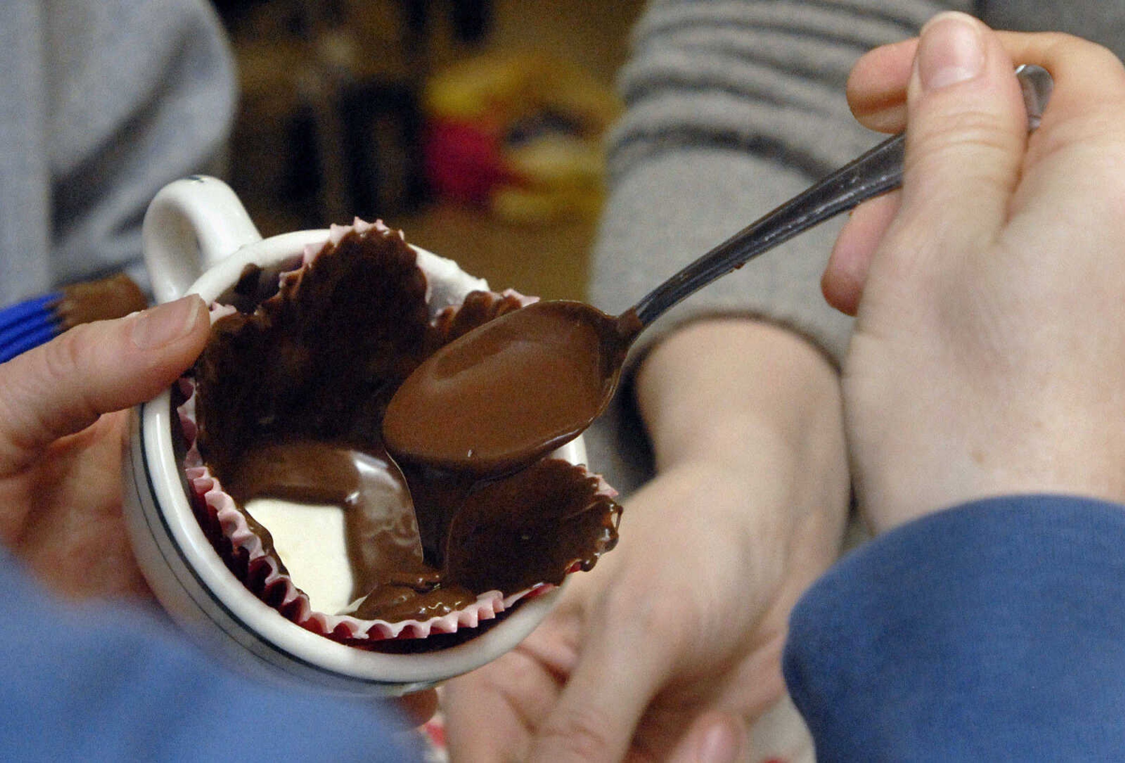 LAURA SIMON~lsimon@semissourian.com
Melted semi-sweet chocolate is added on top of cooled white chocolate to create a duo affect to the chocolate cup Saturday, February 5, 2011.