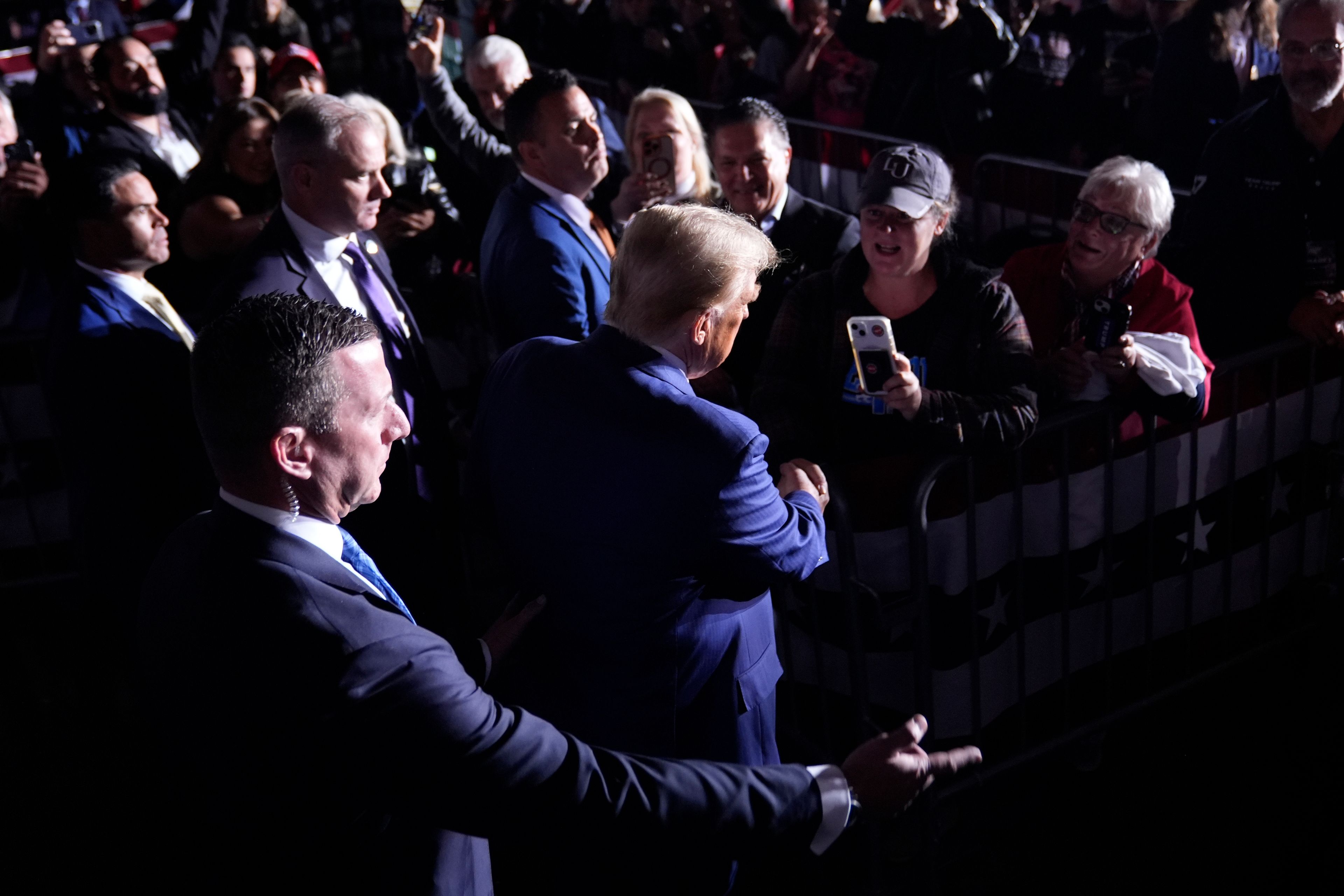 Republican presidential nominee former President Donald Trump greets supporters as he departs after speaking during a campaign rally at the Suburban Collection Showplace, Saturday, Oct. 26, 2024, in Novi, Mich. (AP Photo/Alex Brandon)