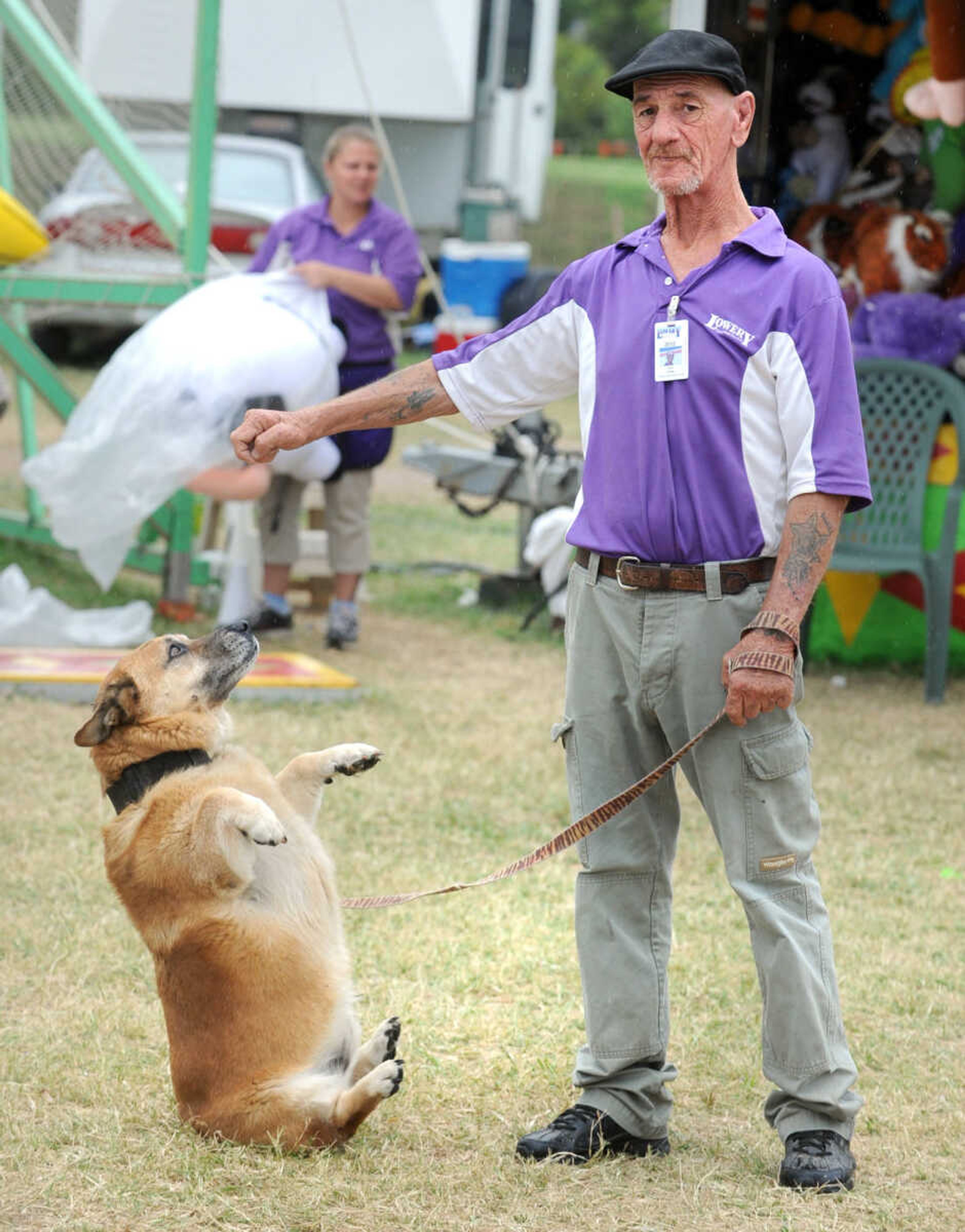 LAURA SIMON ~ lsimon@semissourian.com
Ken Twite's dog, Bear starts to roll back as Twite looks away during the SEMO District Fair Saturday, Sept. 15, 2012 at Arena Park.