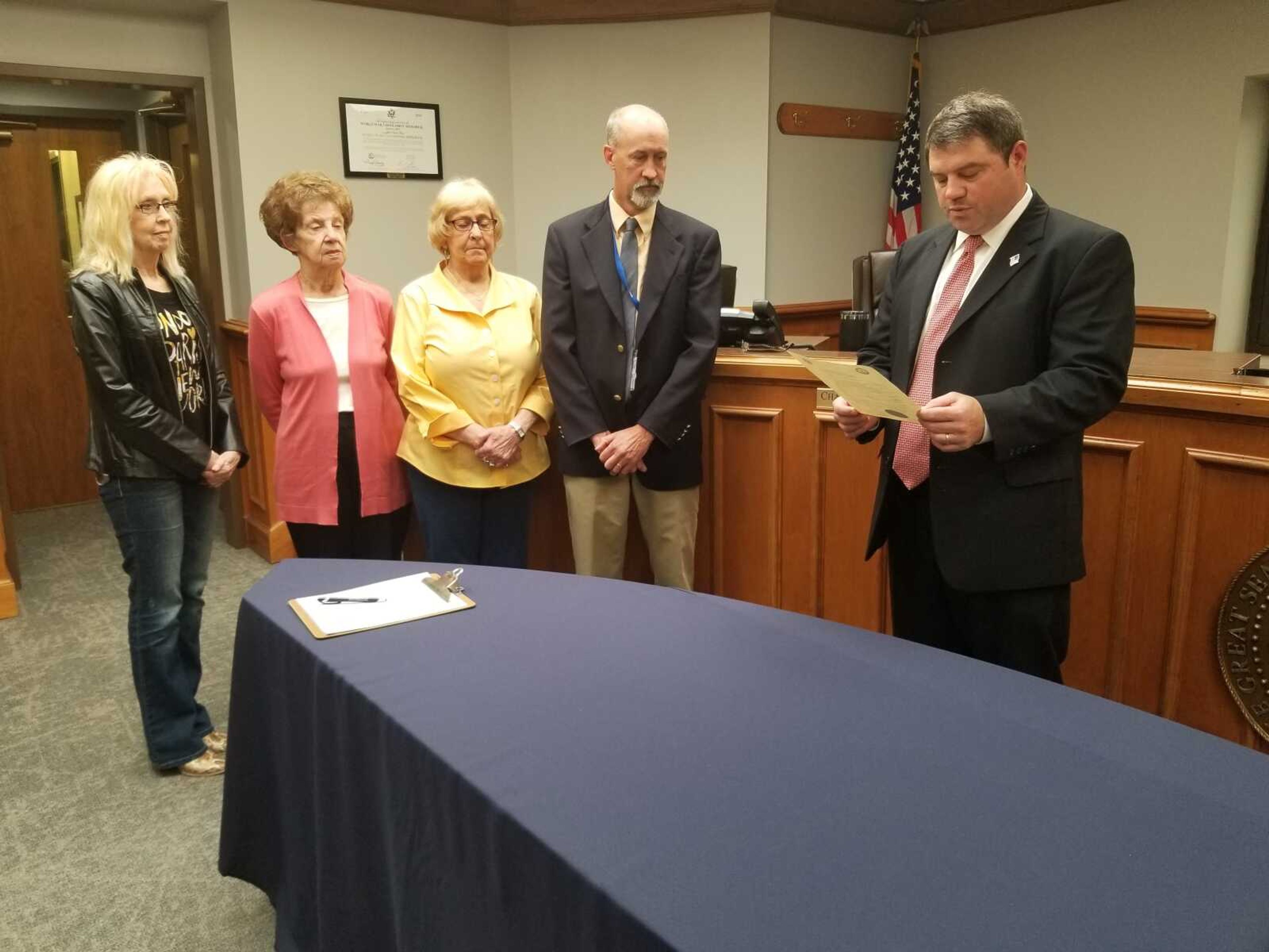 Cape Girardeau County Presiding Commissioner Clint Tracy (right) reads a proclamation Thursday proclaiming May 15 as National Day of the Family in the county. Fellow commissioner Charlie Herbst stands to Tracy's right along with members of the Family Community and Education Organization, May 6, 2021.