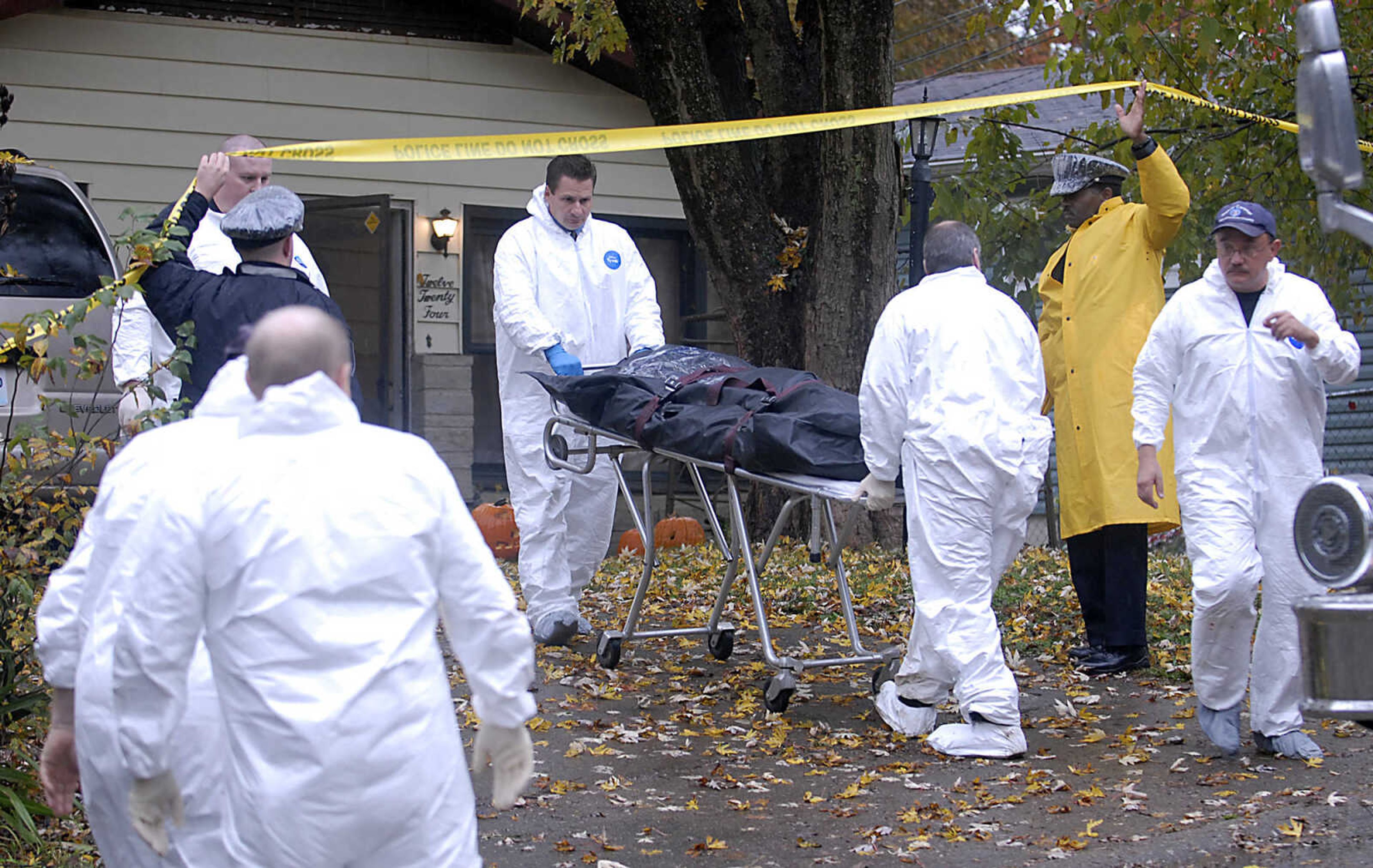 KIT DOYLE ~ kdoyle@semissourian.com
Investigators remove a victim's body from 1224 N. Missouri St. Tuesday morning, October 27, 2009, in Cape Girardeau.  There was a double homicide at the residence early Tuesday morning.