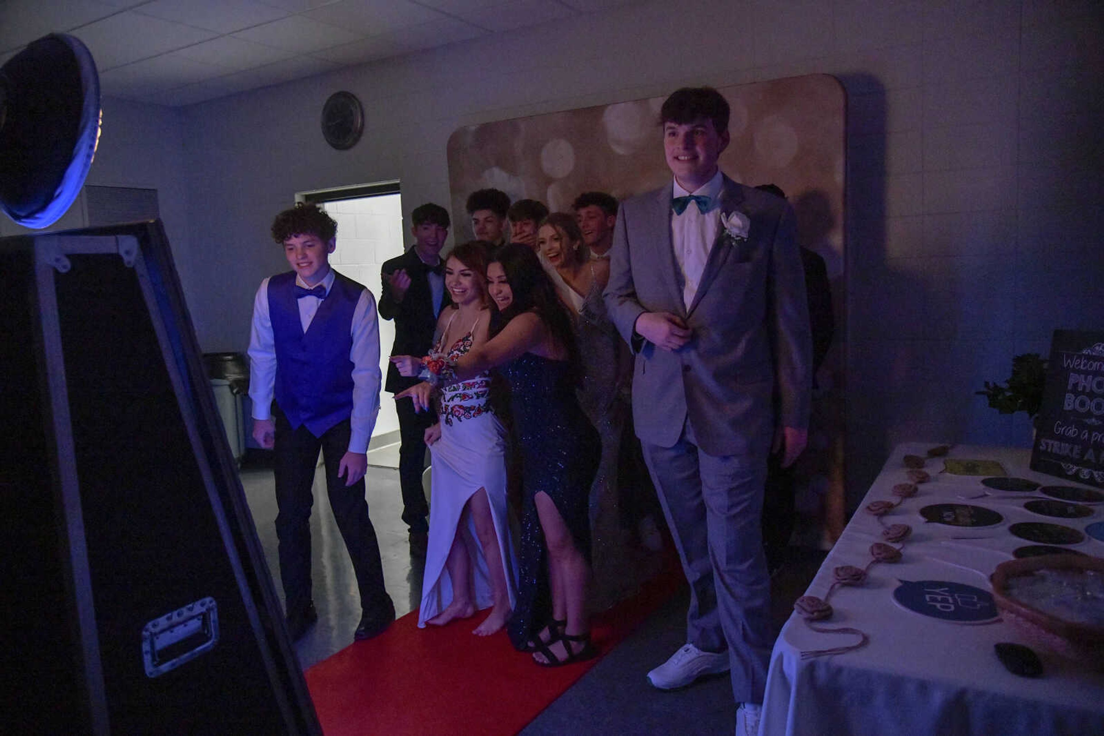 Students react to the photo they just posed for in a photo booth setup during prom at the Front Porch in Scott City on Saturday, April 24, 2021.